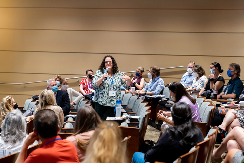 Emily Richards, board member of the Comprehensive Cancer Alliance for Idaho, engages with other summit guests