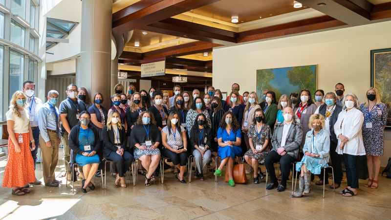 Summit guests and Huntsman Cancer Institute staff pose for a group photo