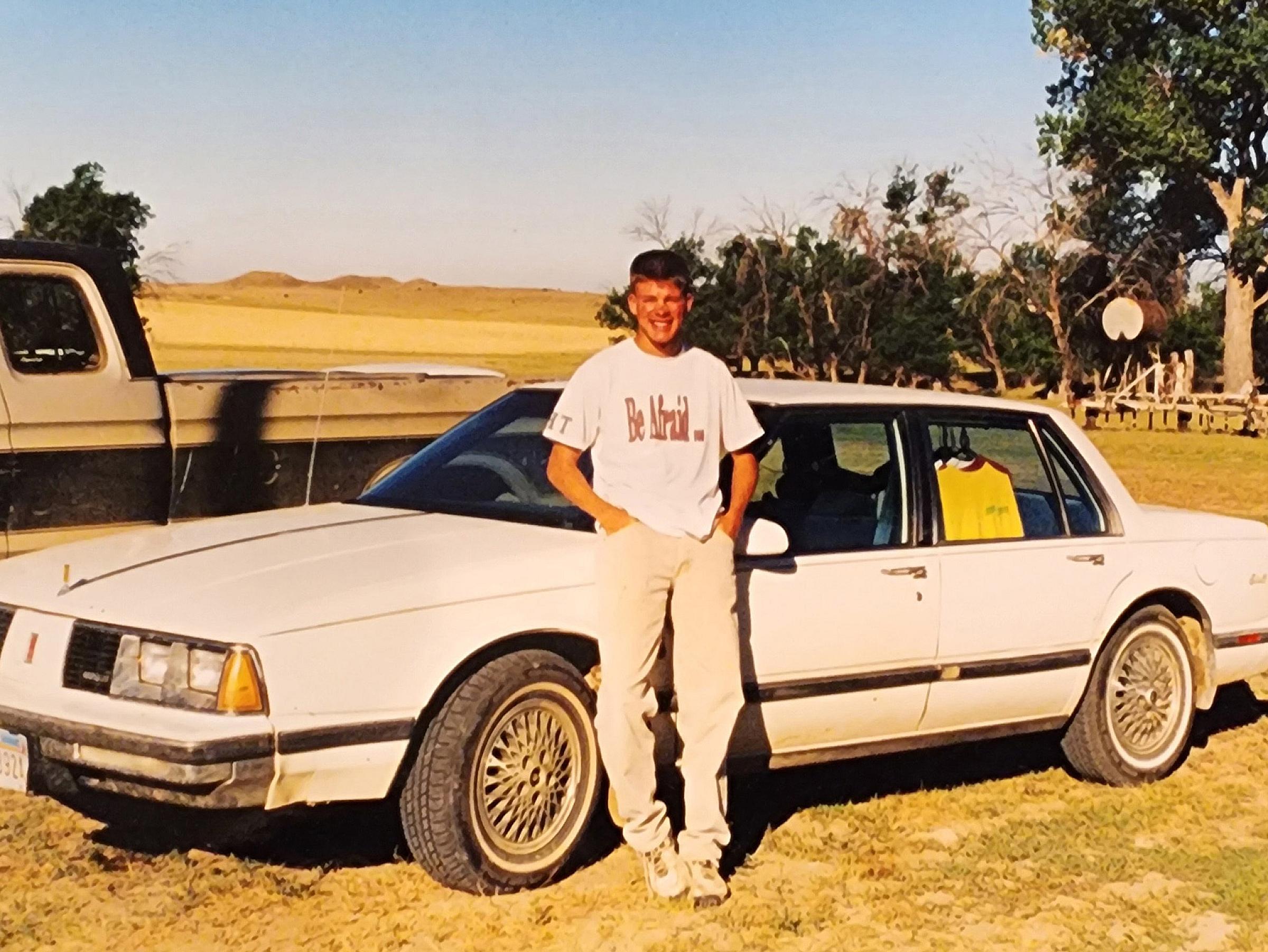 Jakob Jensen leaning up against his car in Circle, MT.