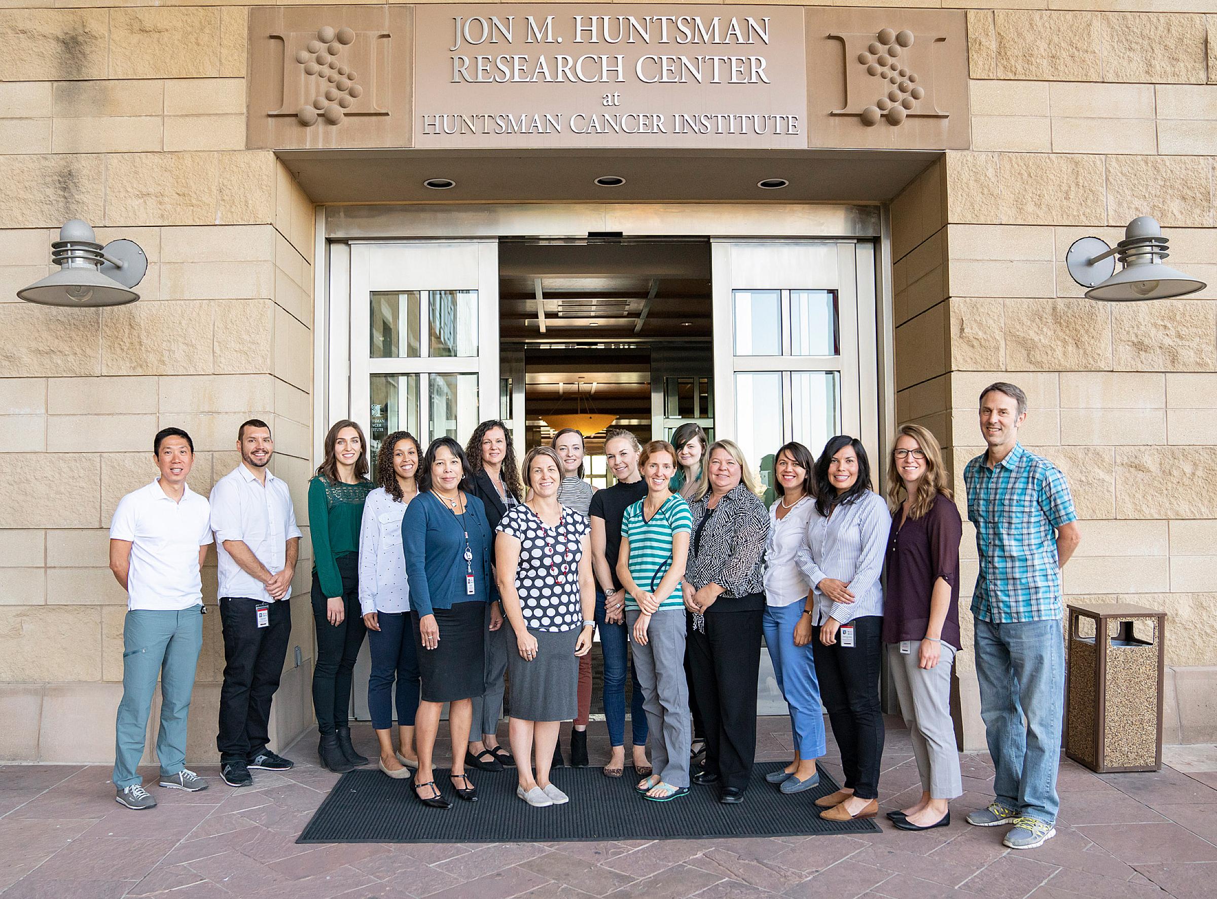 The Center for Health Outcomes and Population Equity (HOPE) team members in front of Huntsman Cancer Institute Research South building
