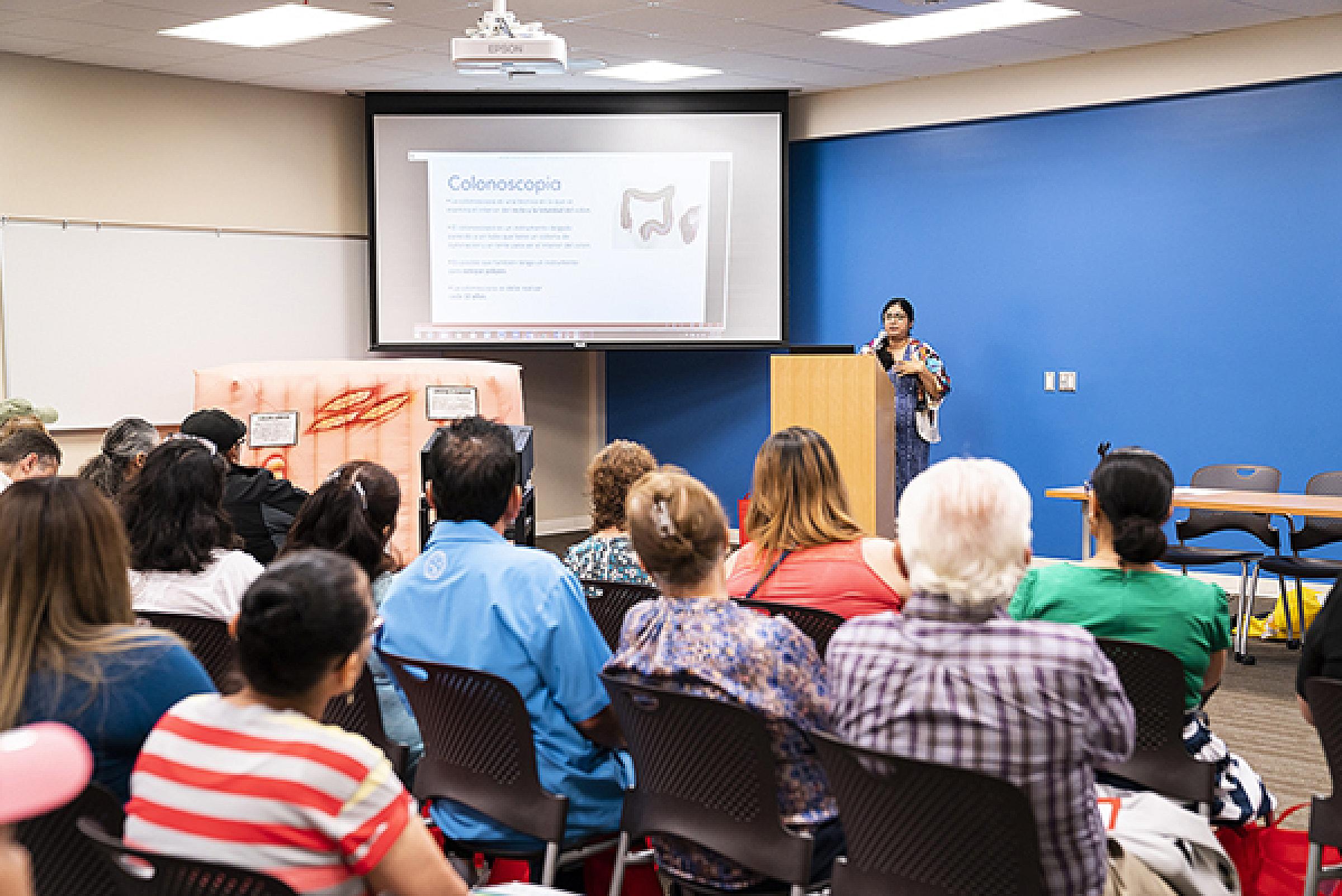 A member of HCI's Community Outreach Team presents information about colon cancer screening.