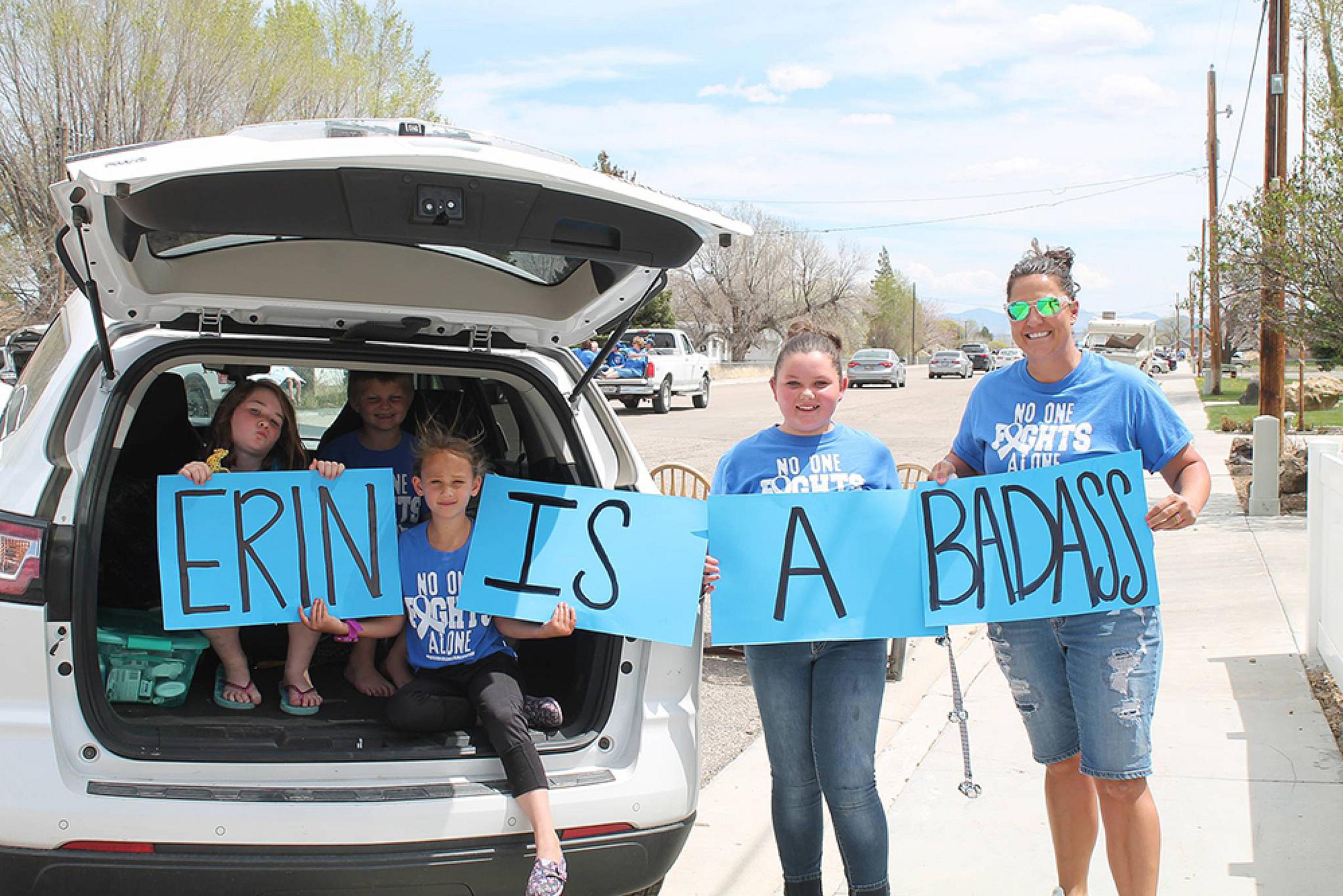 Group of women holding a sign that says Erin is a Badass