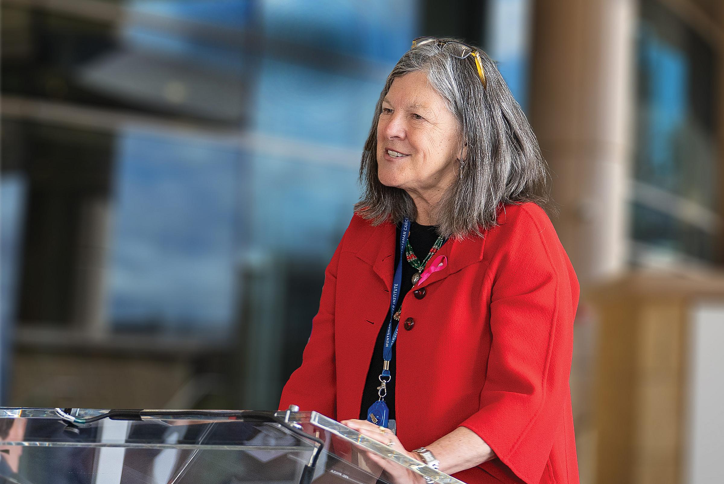 Mary Beckerle, PhD speaking at a podium