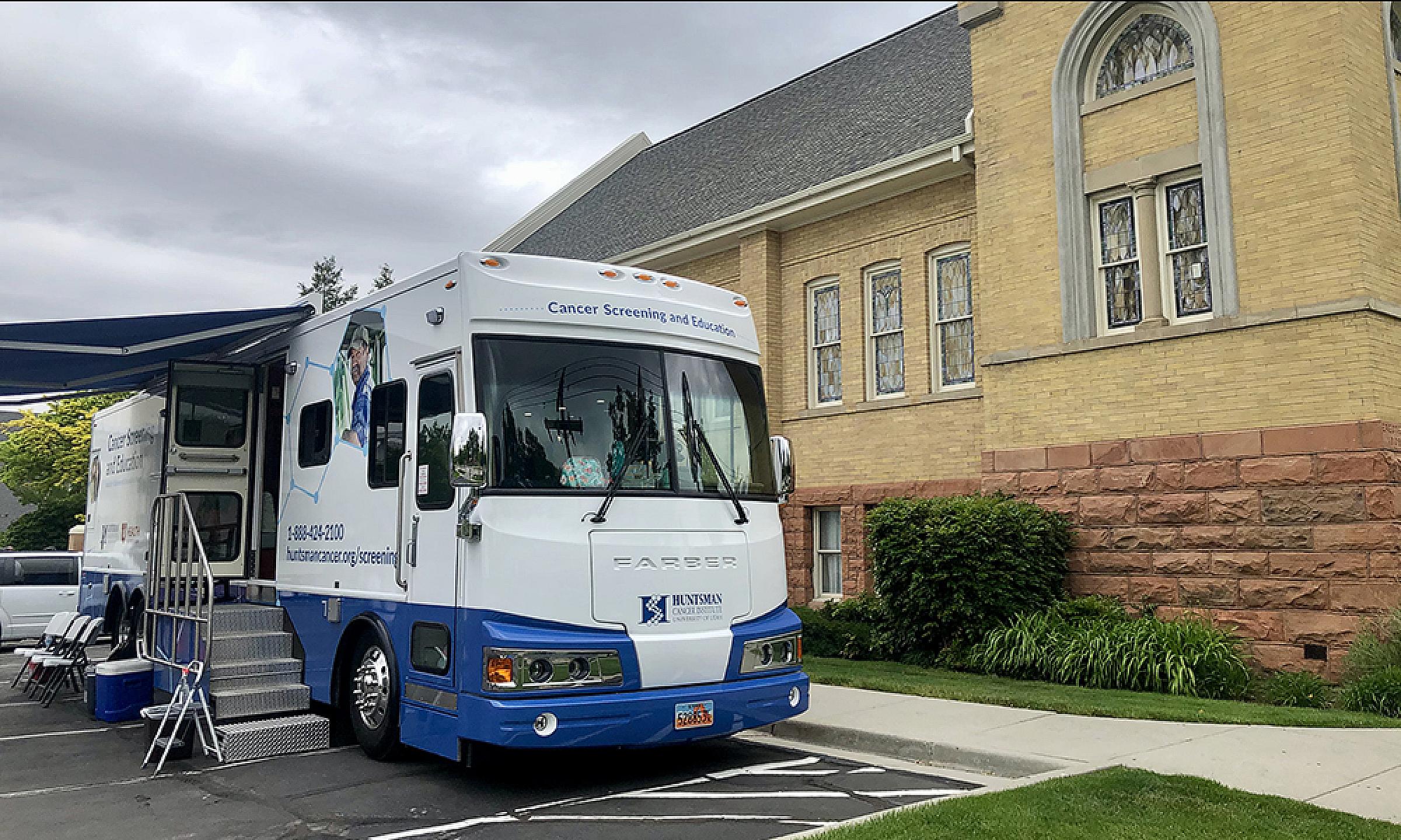 Cancer Screening and Education Bus parked outside a community building