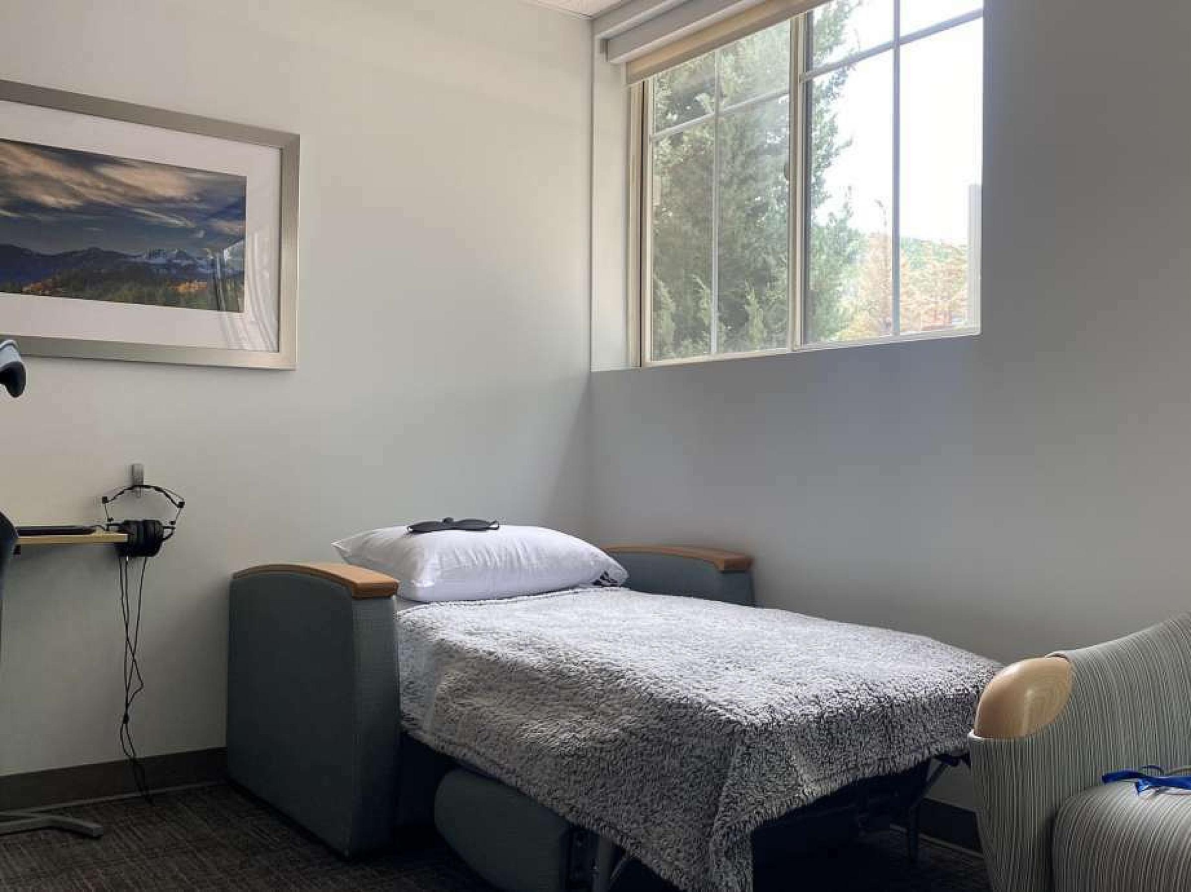 Bed next to a window in the KAP Clinic