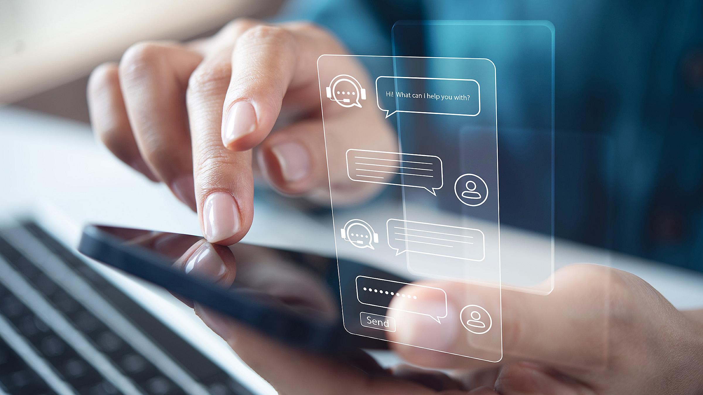 Person typing on their phone with a graphic of their conversation with a chatbot hovering over their screen