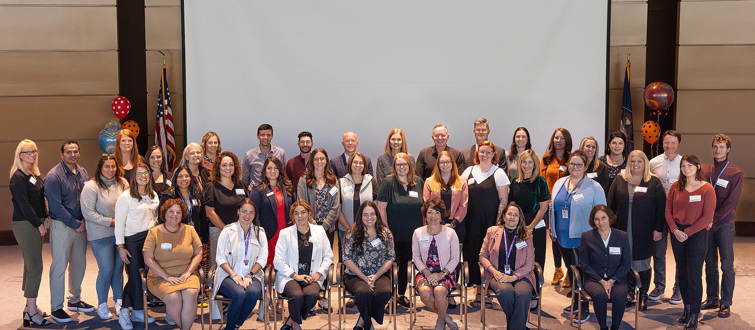 Enjoying each other’s company, attendees take a moment to capture a group photo.