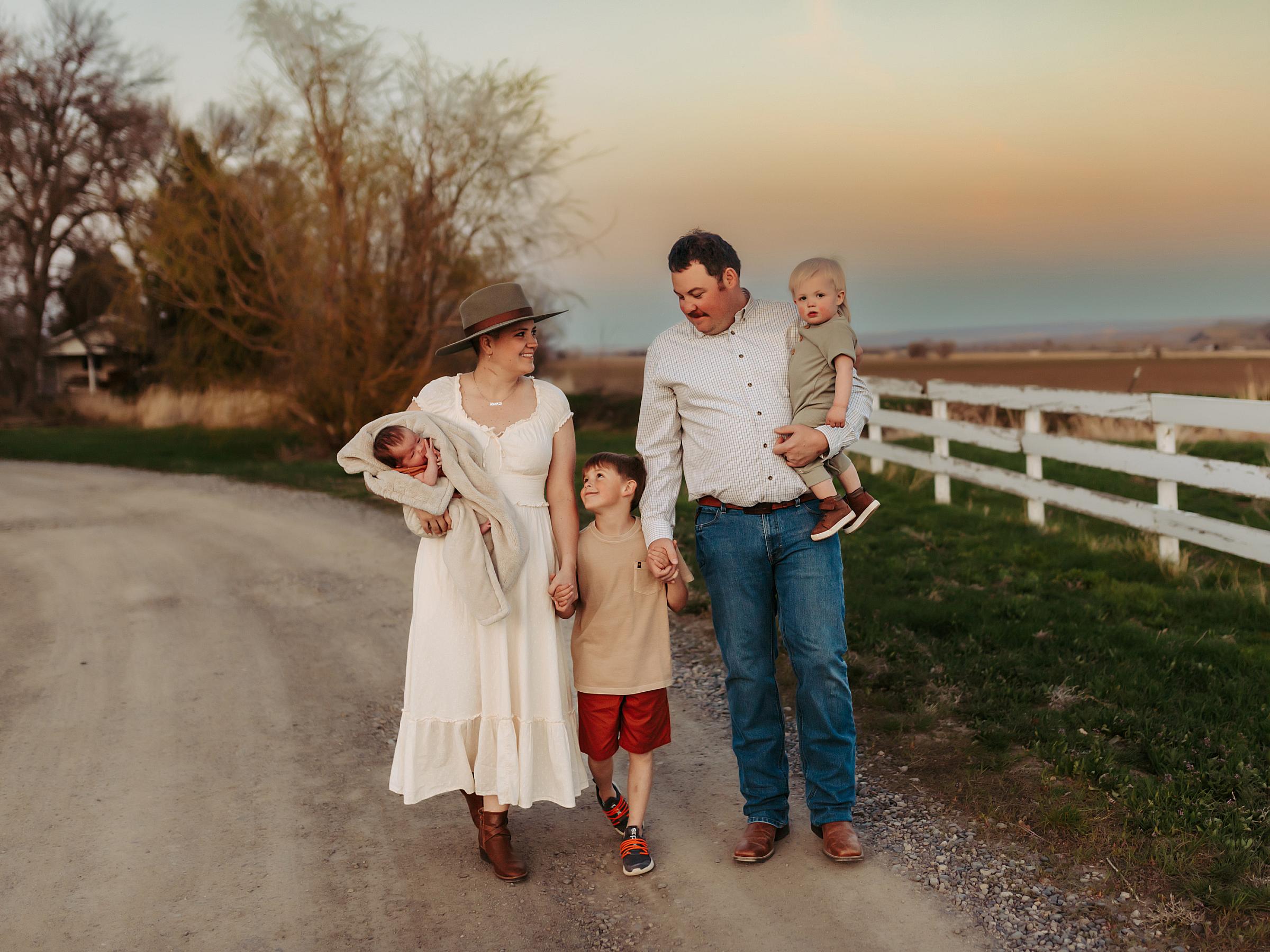 Kaci Popp walking with her family down a dirt road next to a field