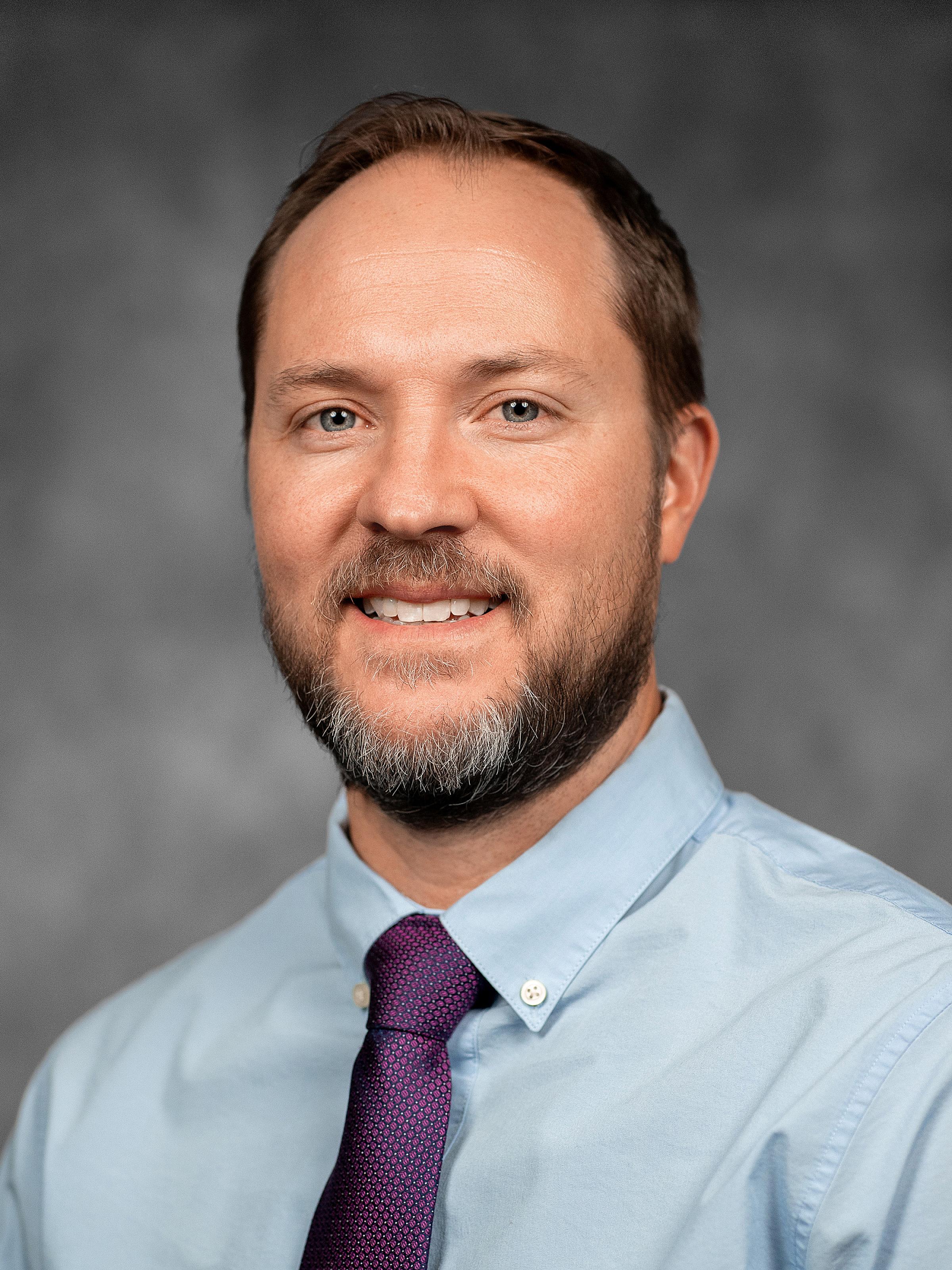 Luke Maese in Blue Dress Shirt and Red Tie Portrait