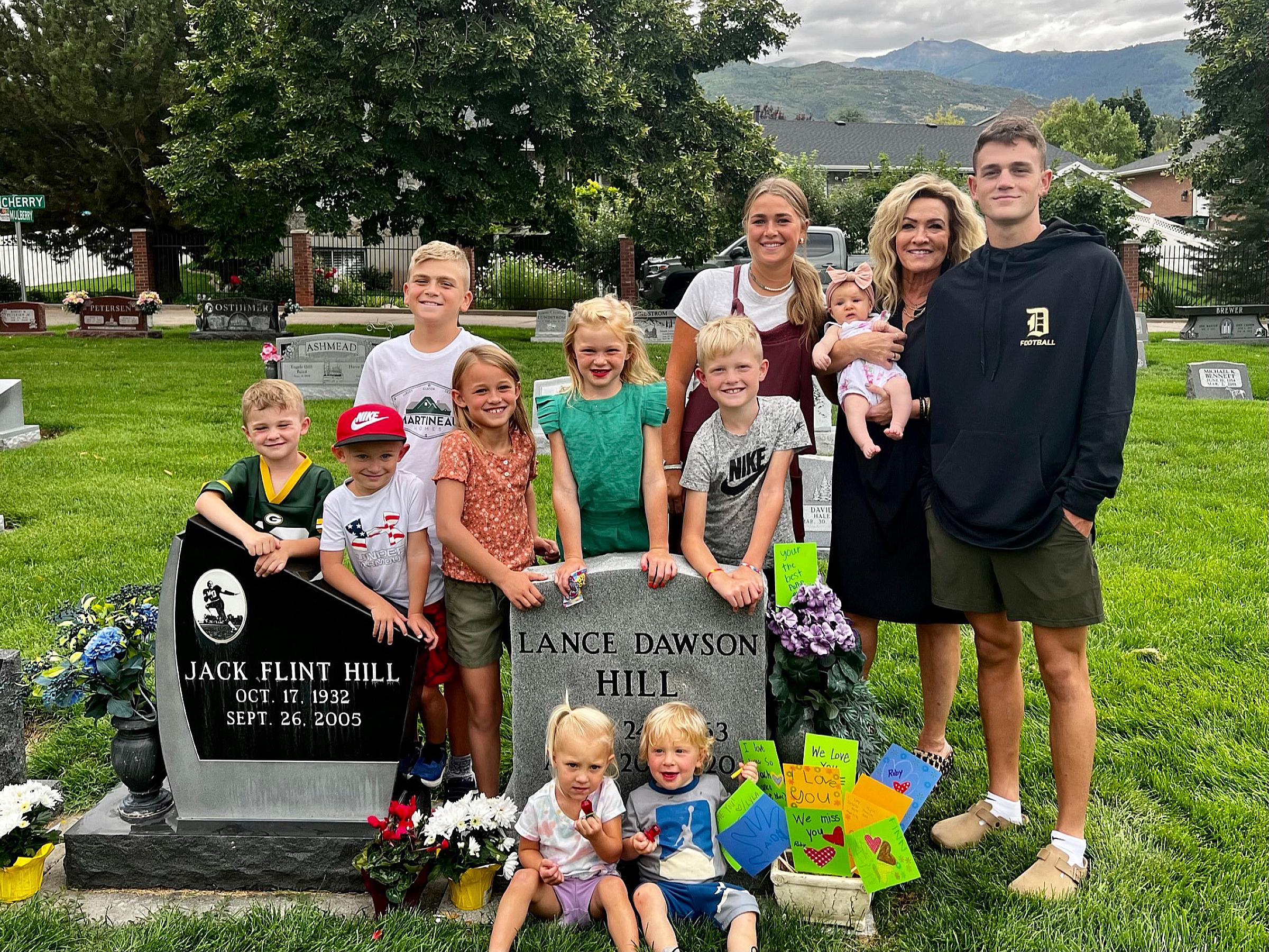 Ruth and her children and grandchildren visiting her husband's gravestone