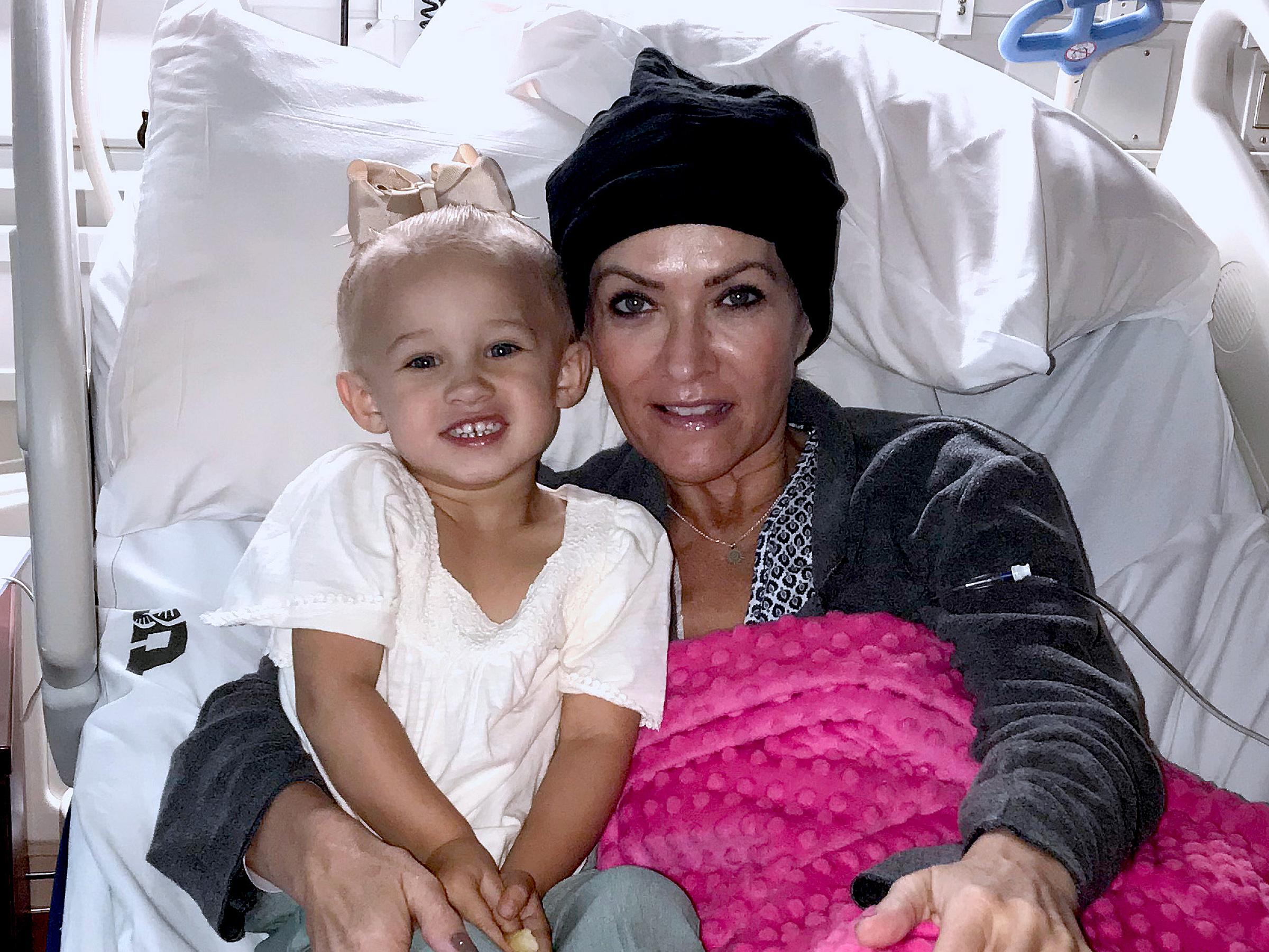 Ruth Hill sitting on a hospital bed with one of her grandchildren