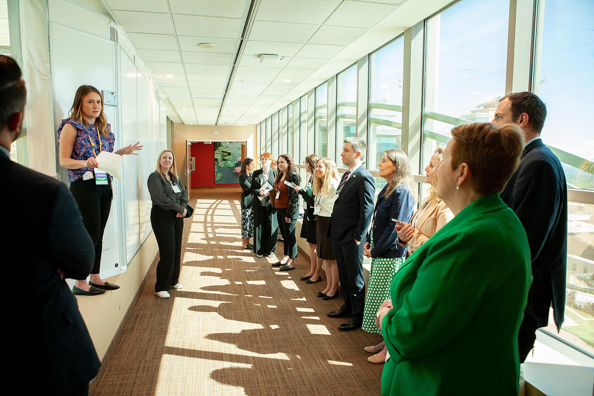 Tour group standing on the skybridge between buildings at Huntsman Cancer Institute