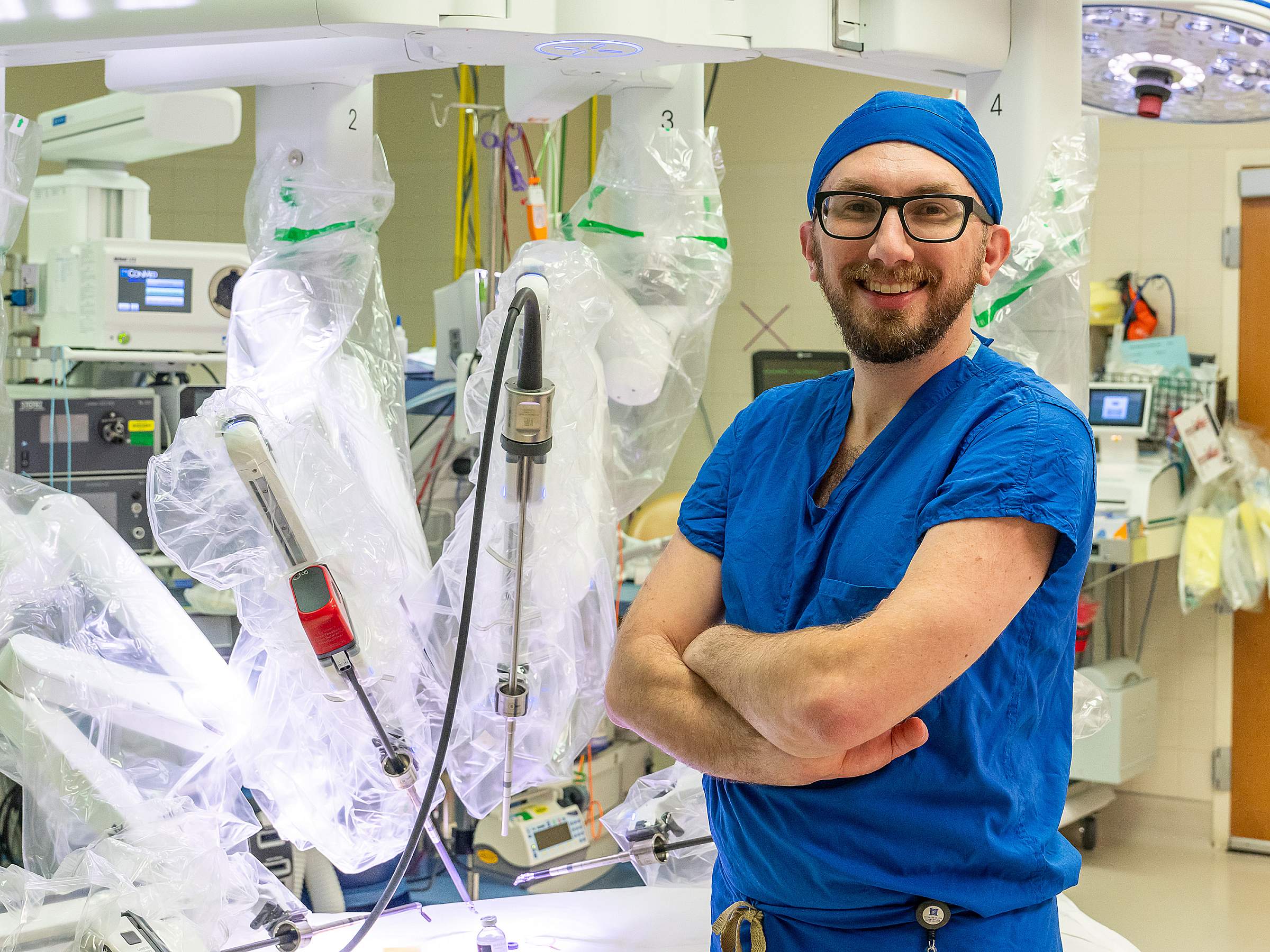 Brian Mitzman, MD, MS, FACS, FCCP, in front of the Da Vinci 5 Surgical System