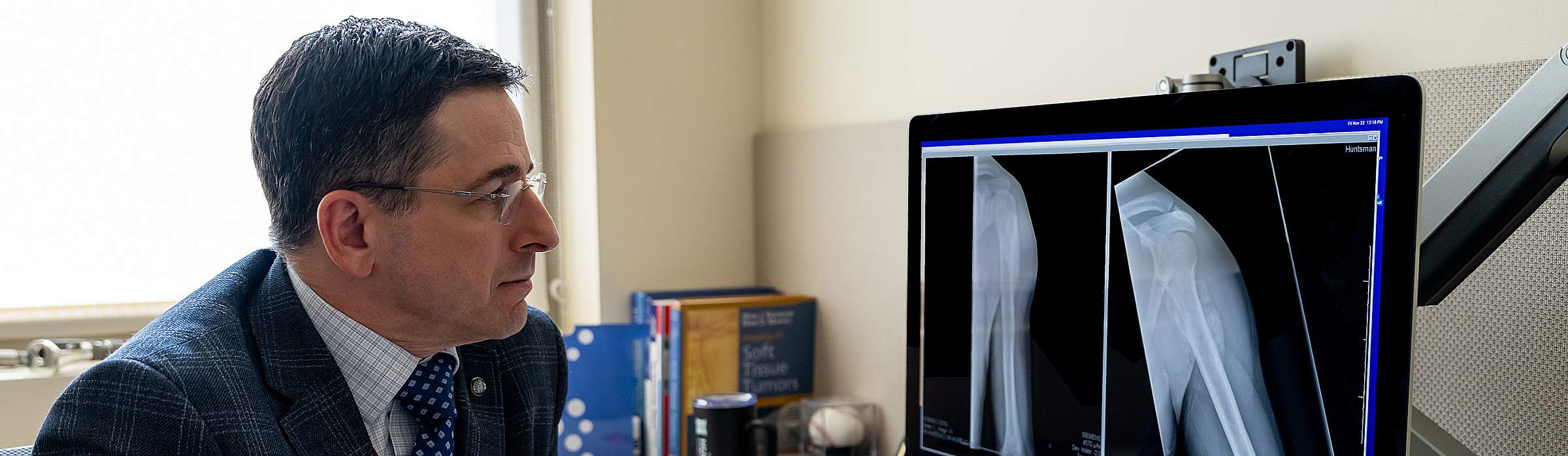John Groundland, MD, looking at x-rays on a a computer