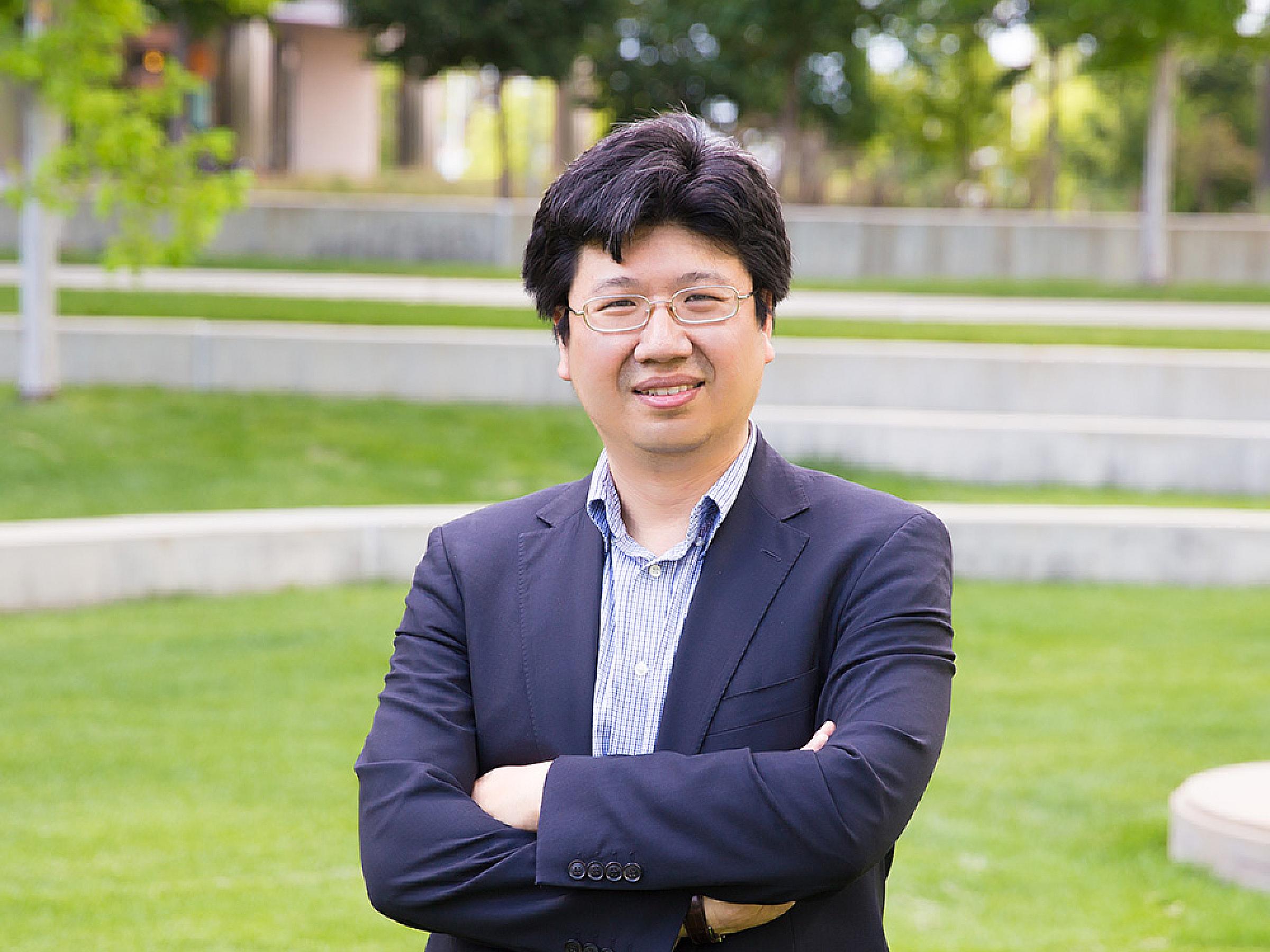 Aik Choon Tan standing, folding his arms