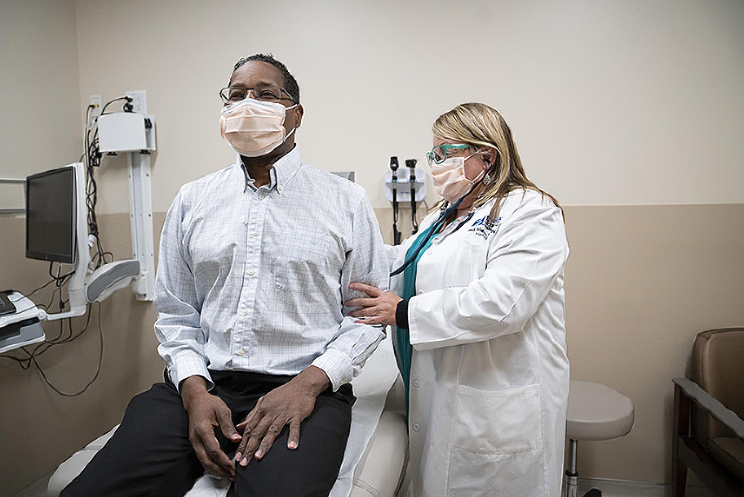 APRN examining male patient