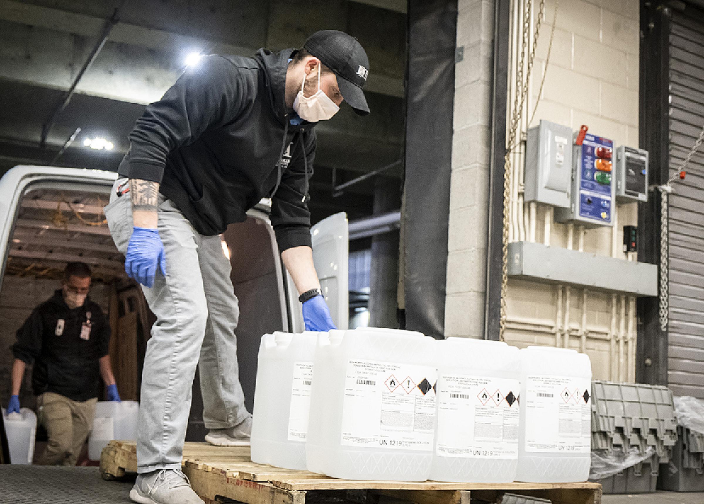 dock employee unloading hand sanitizer