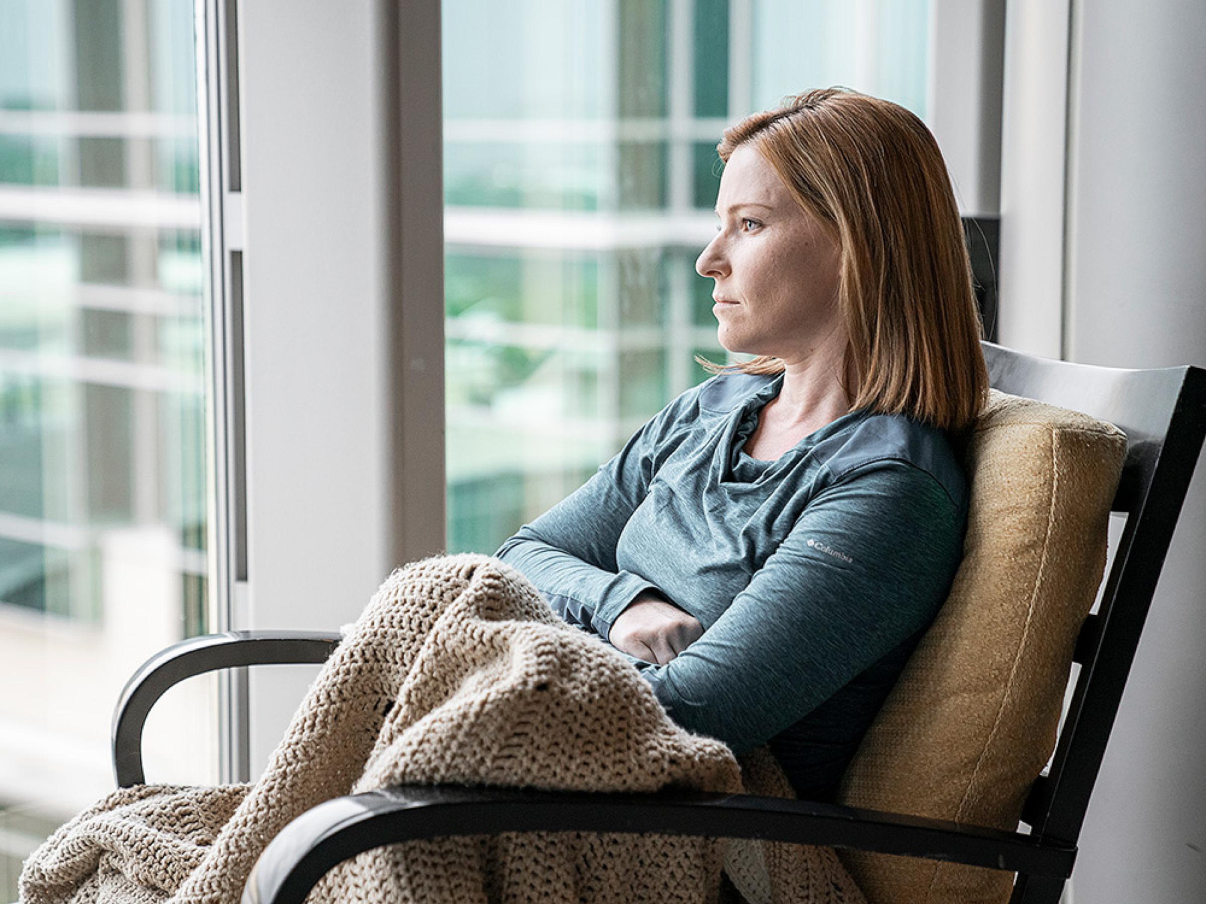 Woman sitting in chair with blanket