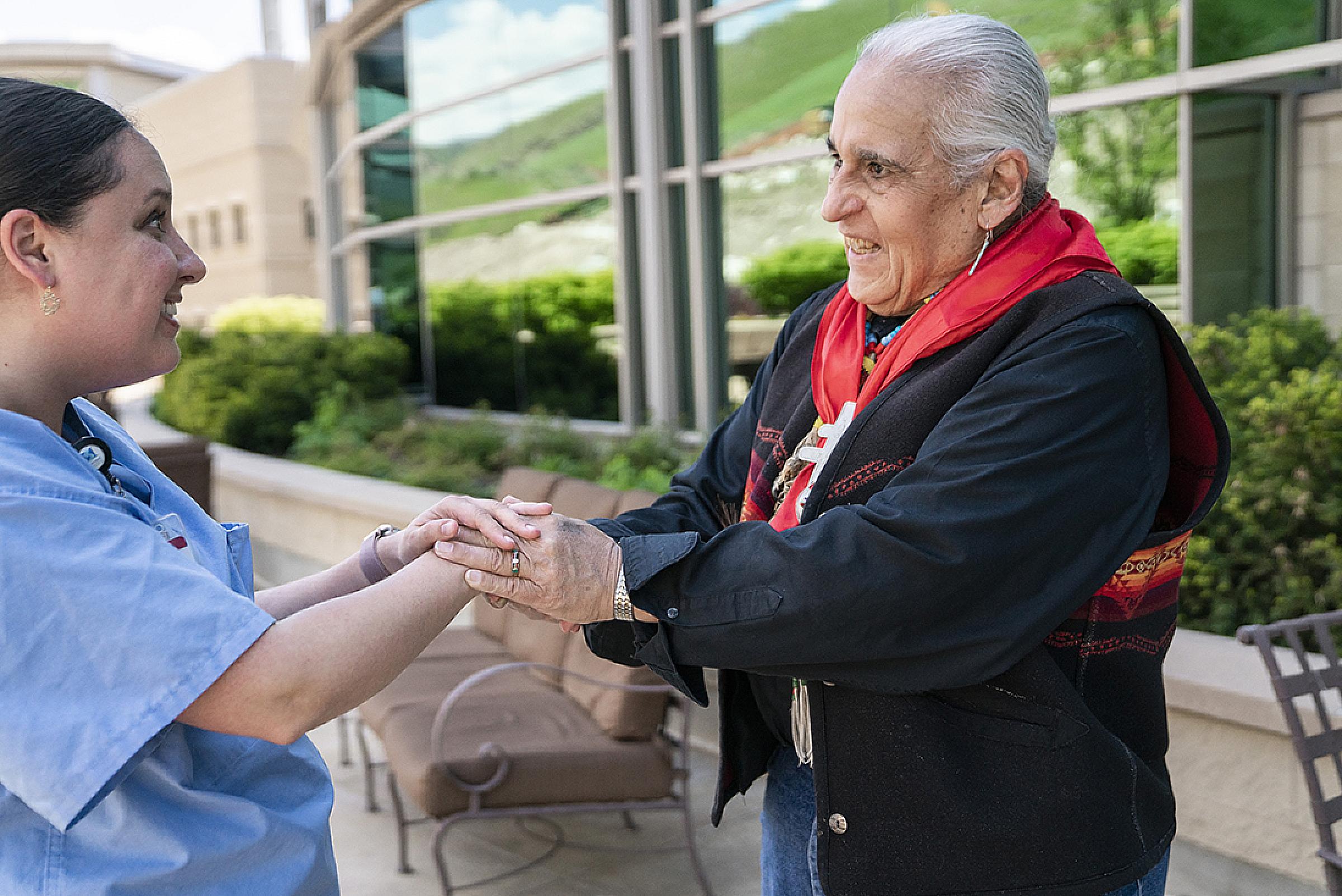 Lacee Harris holding hands with a nurse