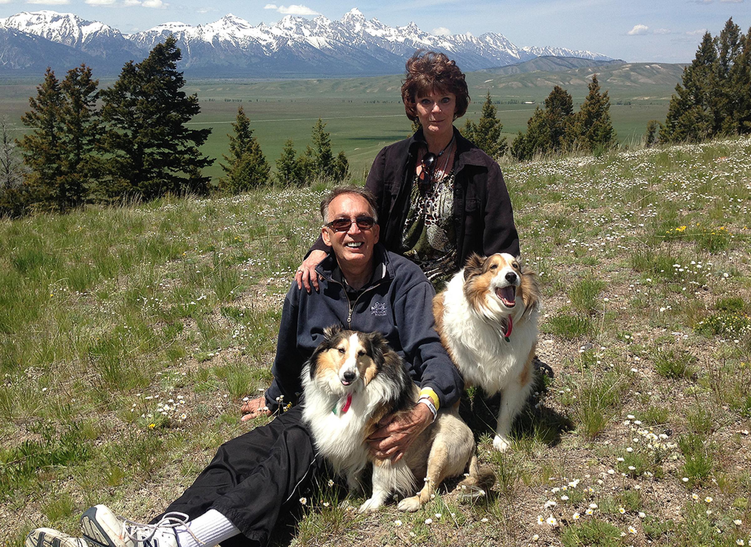 Kenneth and Rose Henderson with their dogs on a hillside