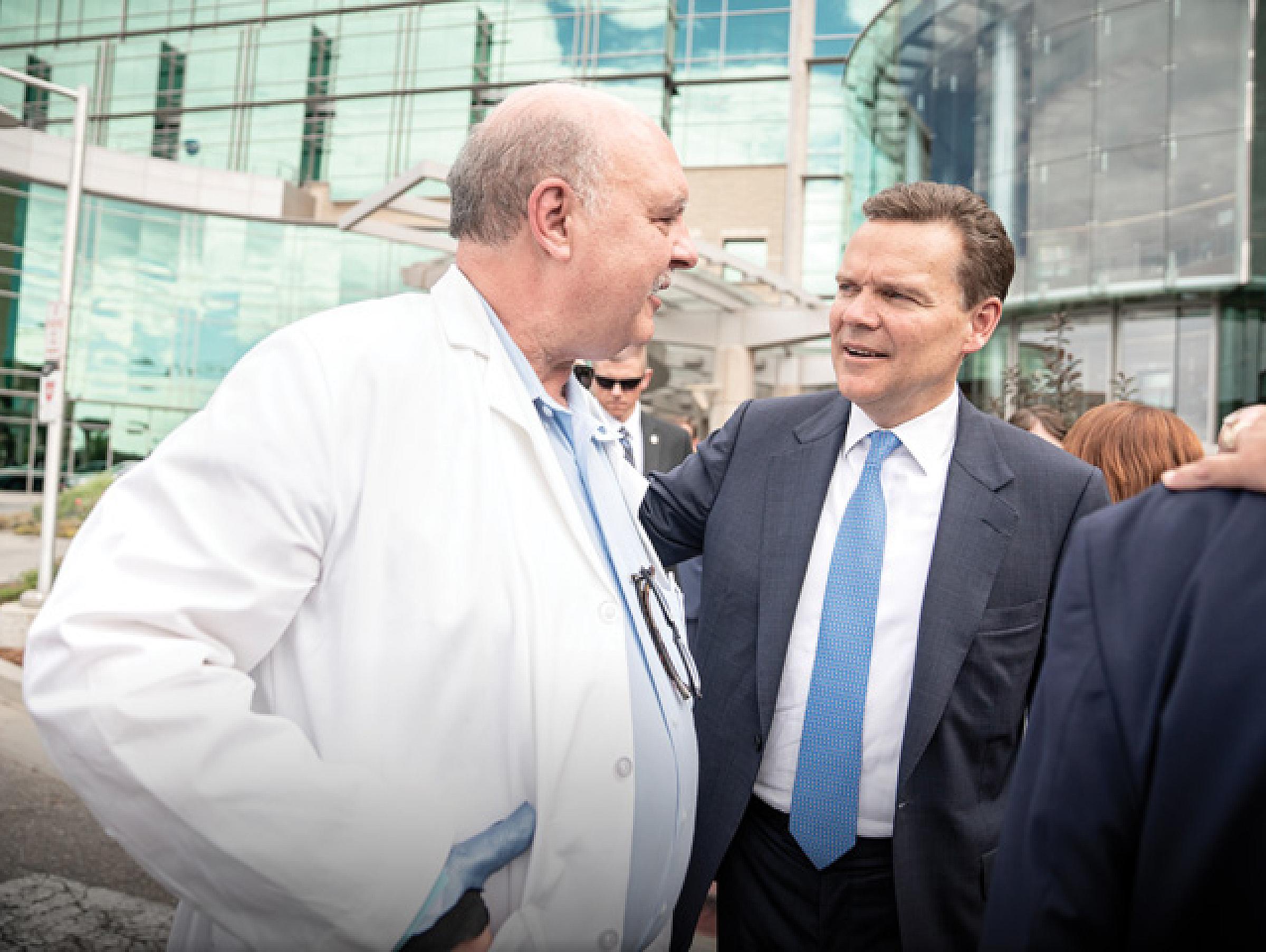 Peter Huntsman and John Weis greet each other at the Kirk Center groundbreaking
