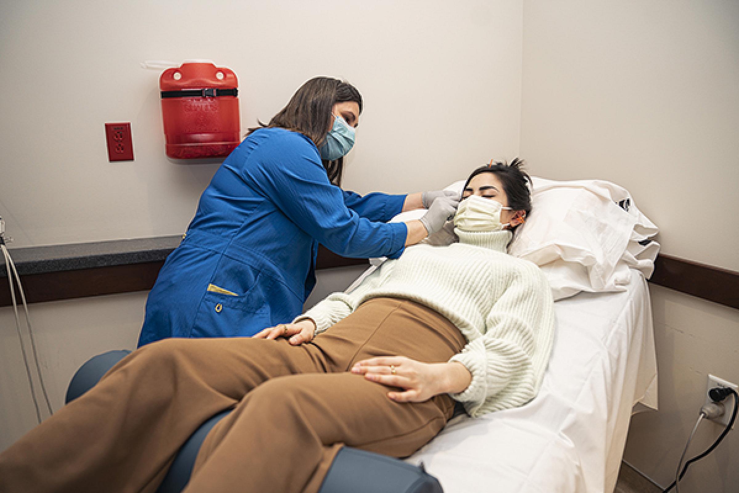 Annie Budhathoki, DAOM, LAc and an acupuncture patient