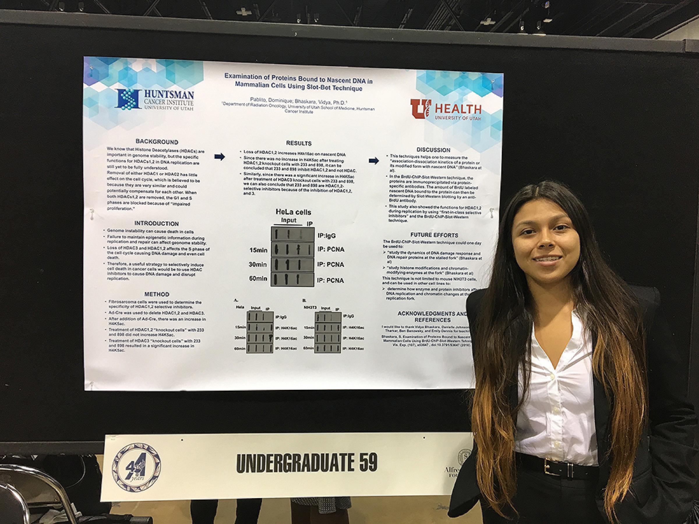 Dominique Pablito in front of information board as an undergraduate