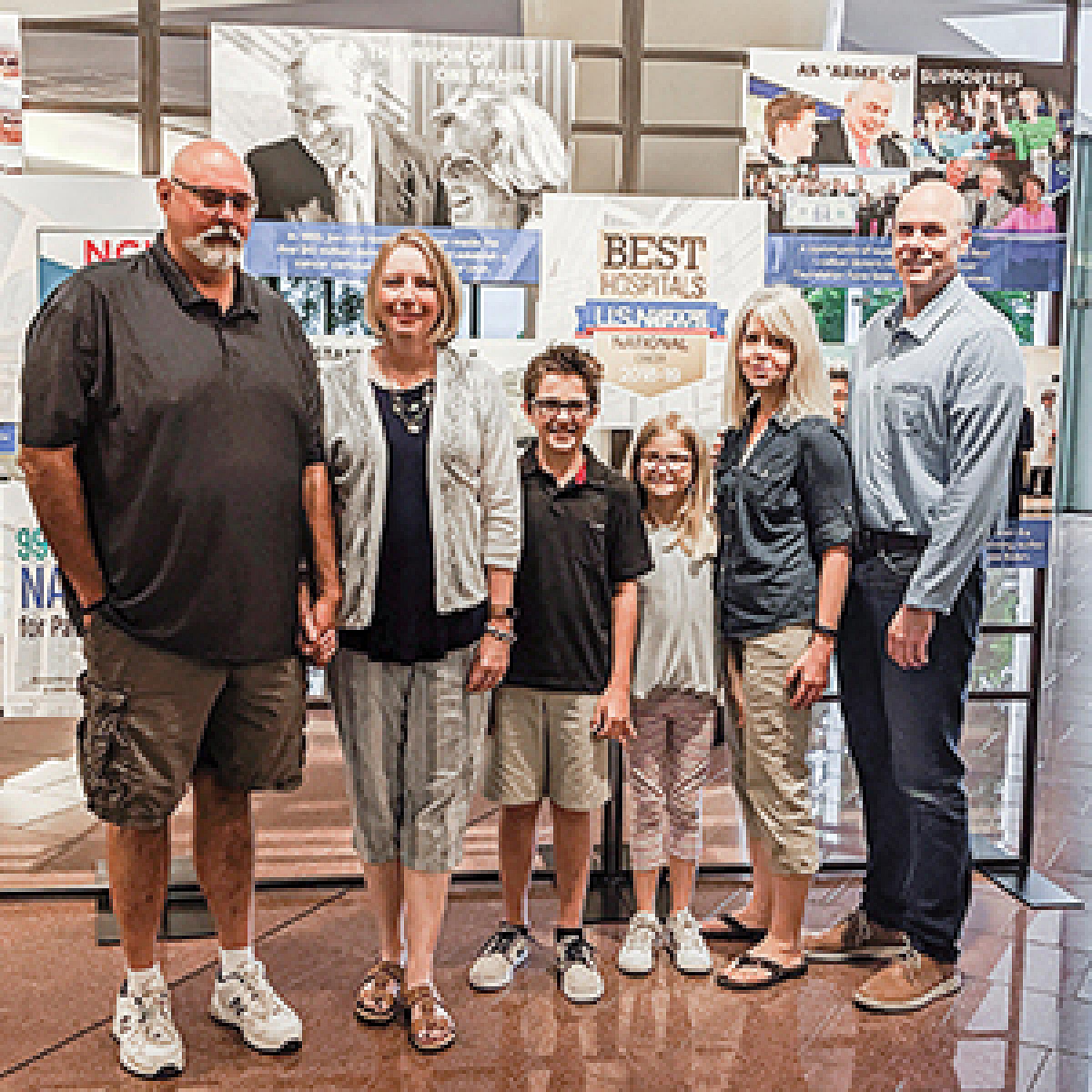 Will Jackman standing with his family at HCI