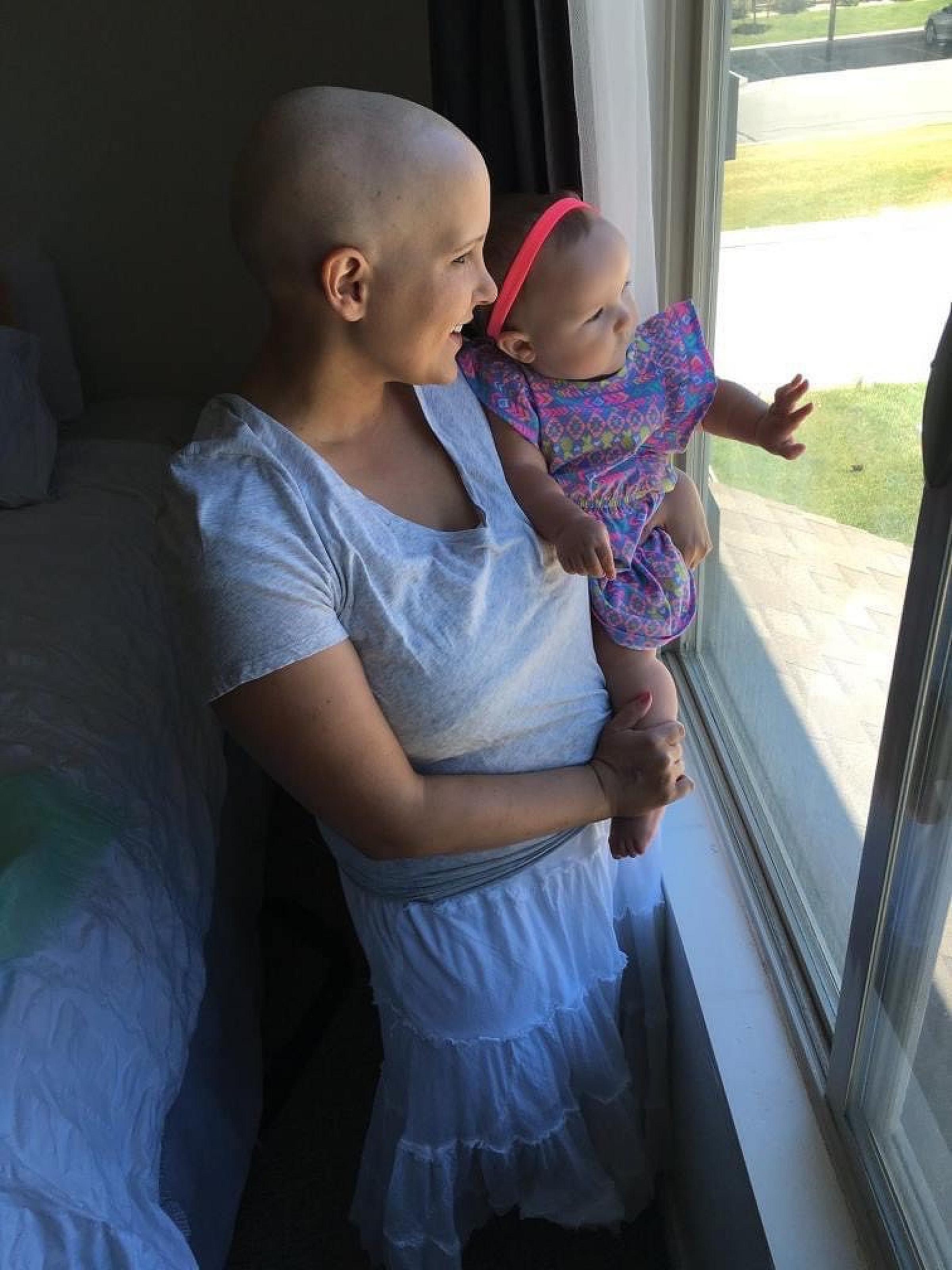 Lisa Lyon holding her daughter during treatment