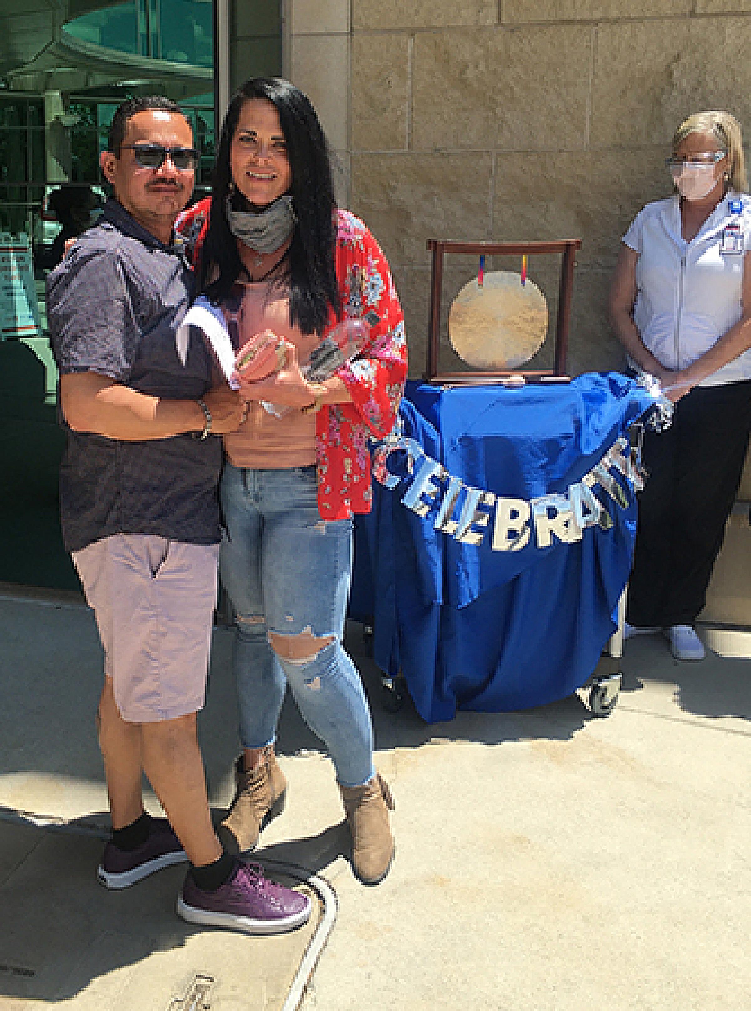 Rikki and George Morales Pose Outside Celebration Gong
