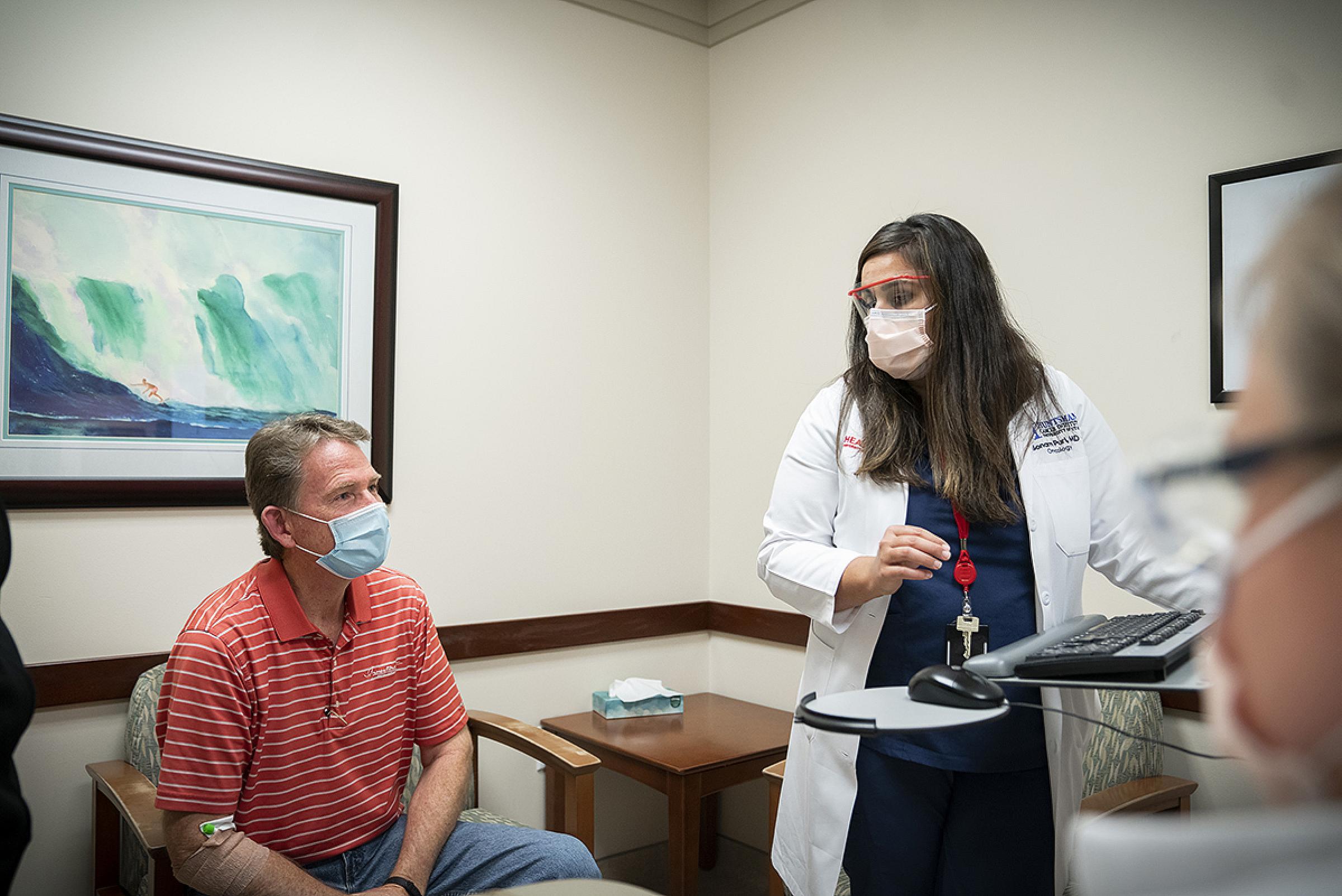 Scott Vance speaking with Sonam Puri in hospital room