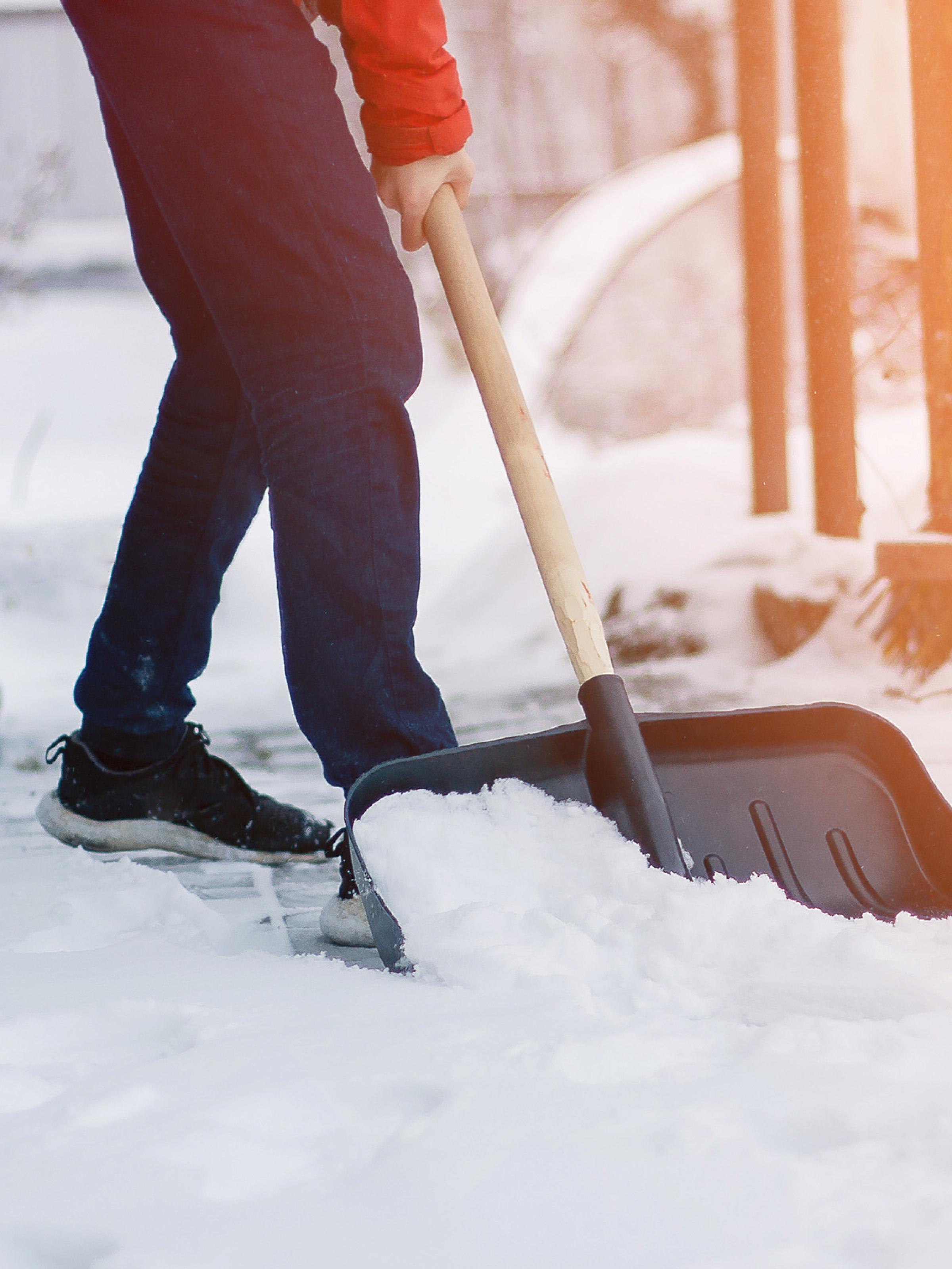 Person shoveling snow out of a walkway