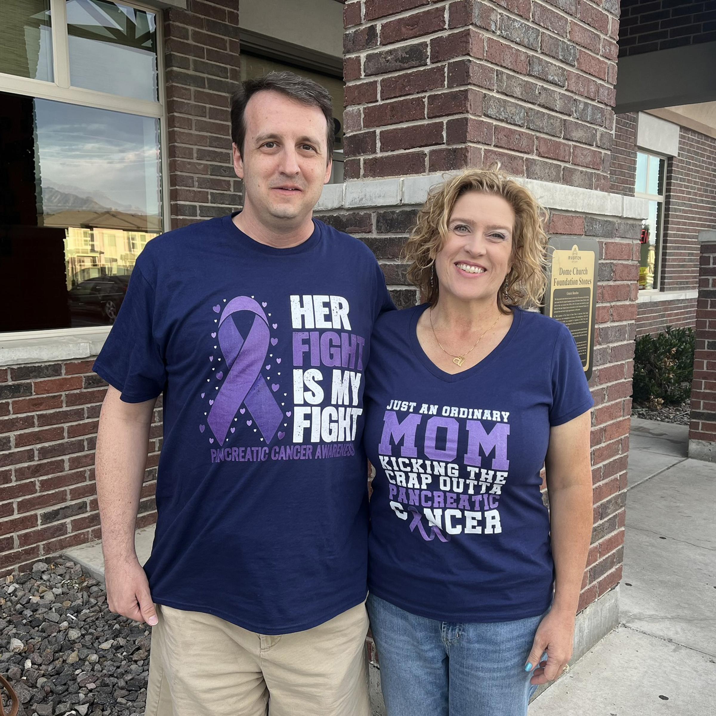 Noelle Gatlin and her husband wearing shirts with a purple ribbon on them for pancreatic cancer
