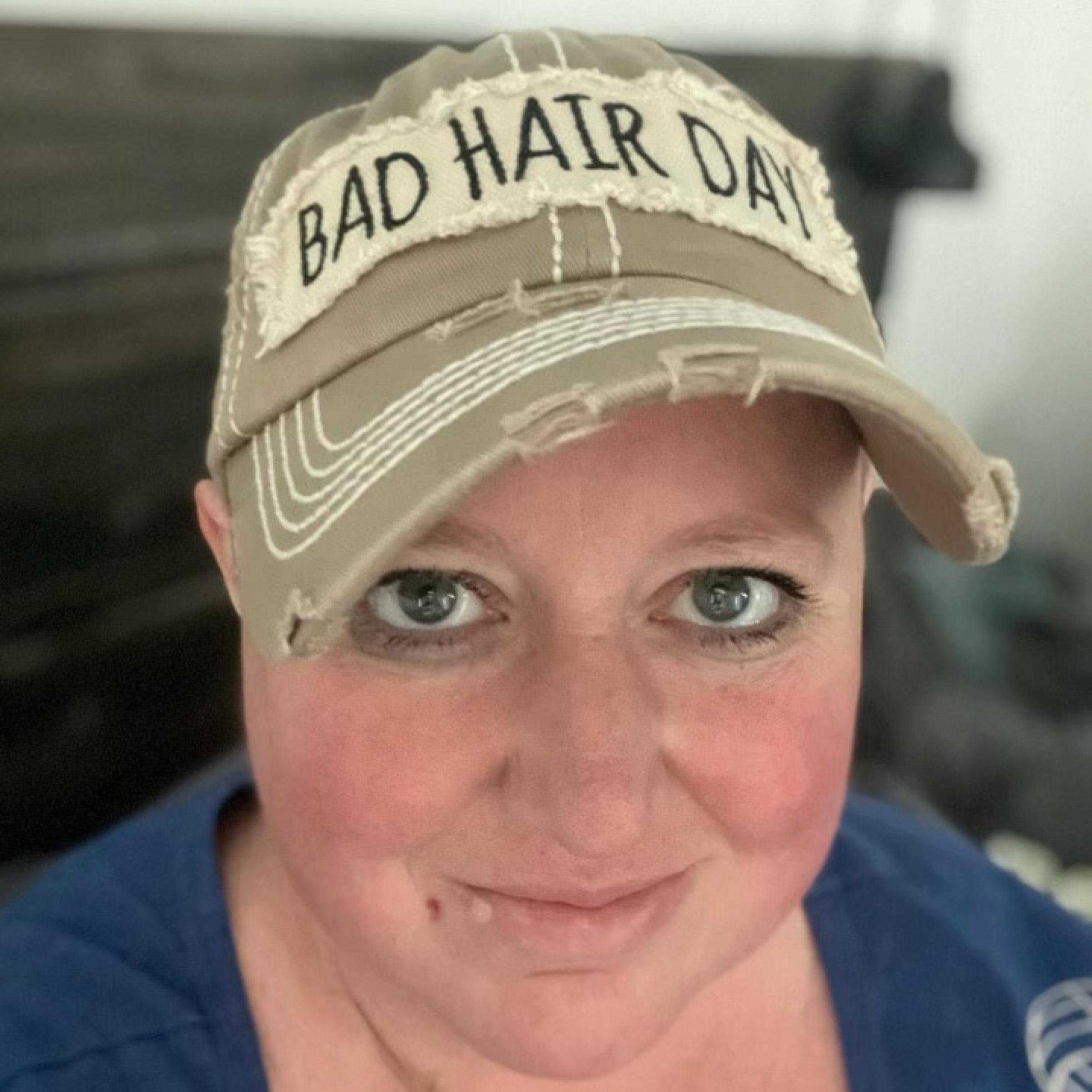 Sara Orgill wearing a hat that says Bad Hair Day