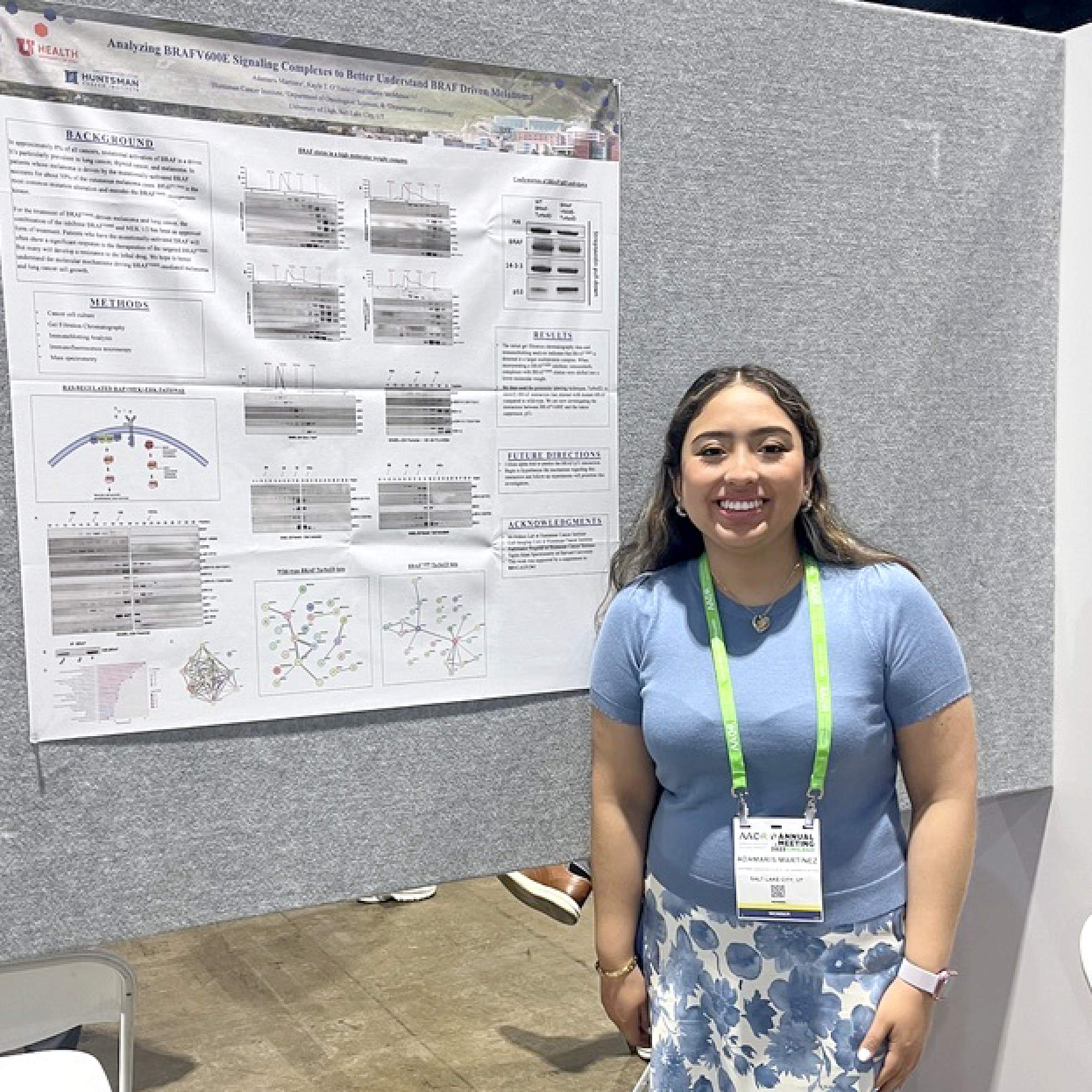 Adamaris Martinez with her research poster at AACR