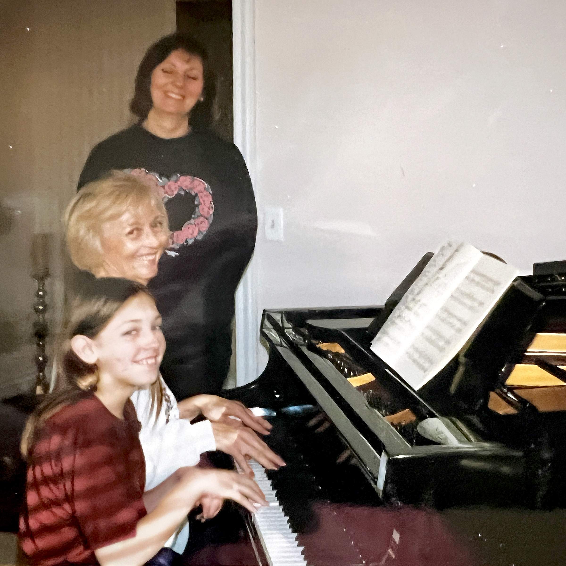 Breanne's grandmother teaching her how to play piano