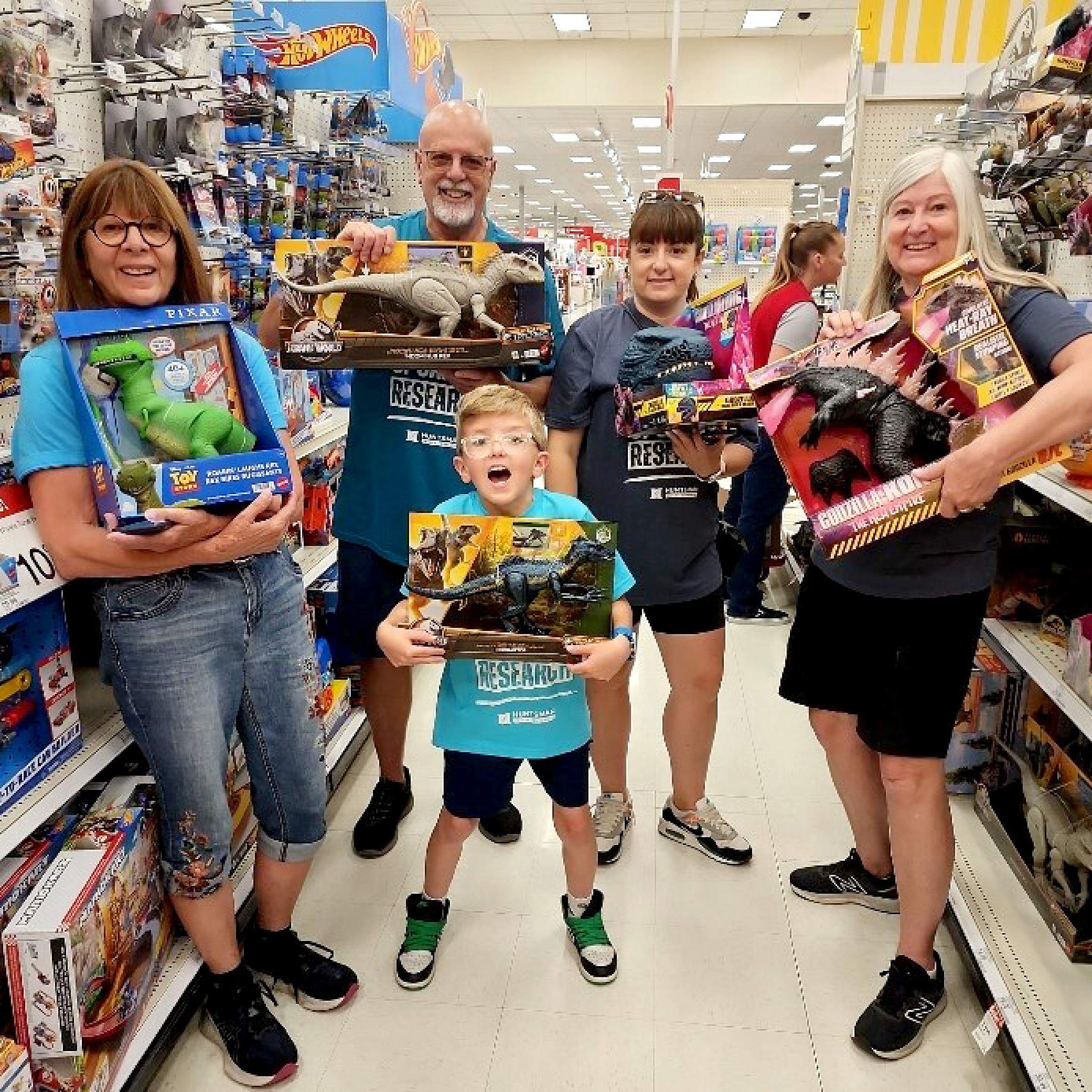 Jerry Barber and his family holding toys in a store