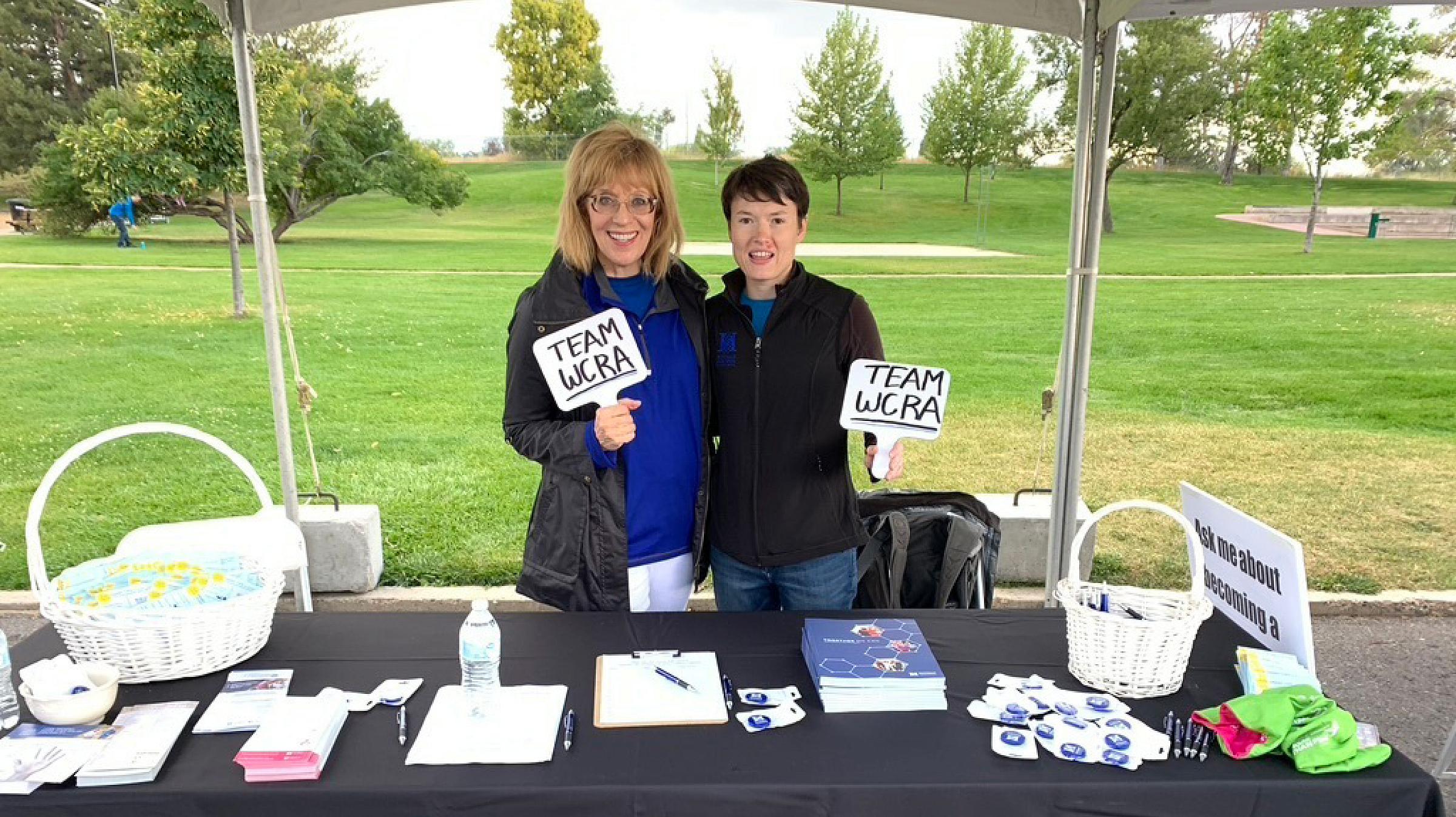 Committee chair and co-founder Carla Lloyd, and the group's first scientific liaison, Jaime Fornetti, PhD, work the advocate committee's booth at the Susan G. Komen More than Pink Walk.