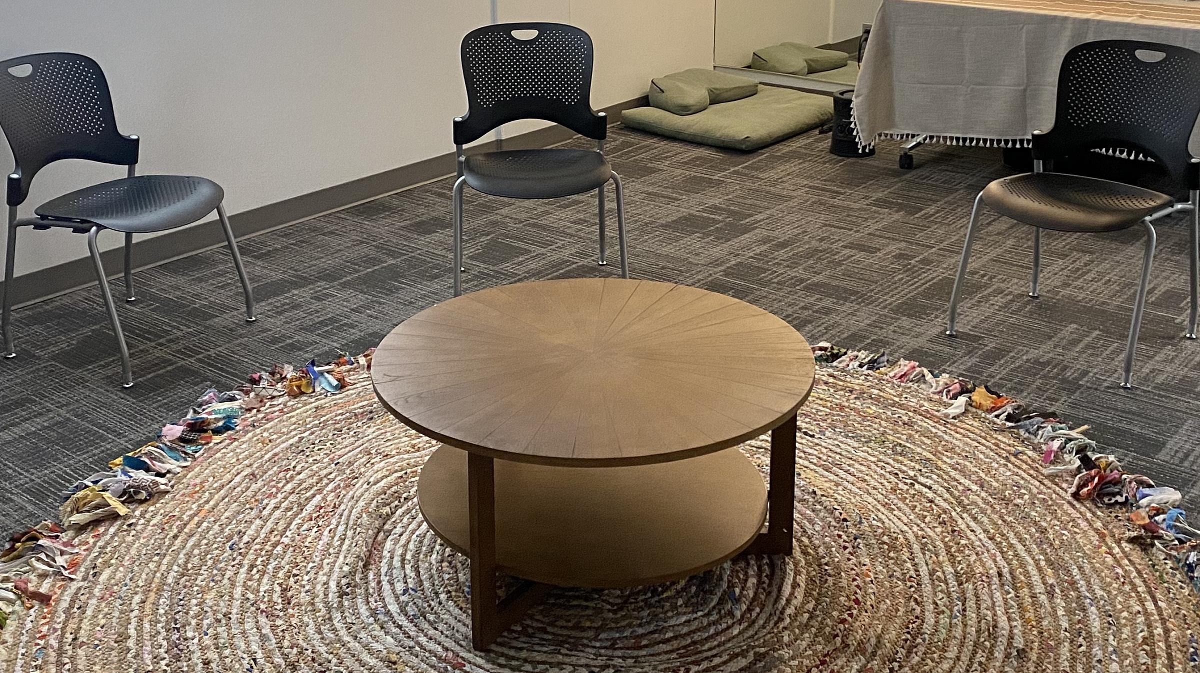 Circle of chairs around a small table at the KAP Clinic
