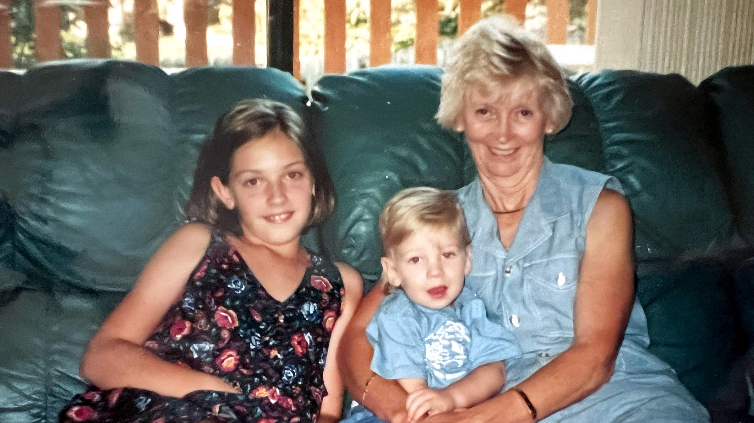 Breanne Eddington with her brother and grandmother on a couch