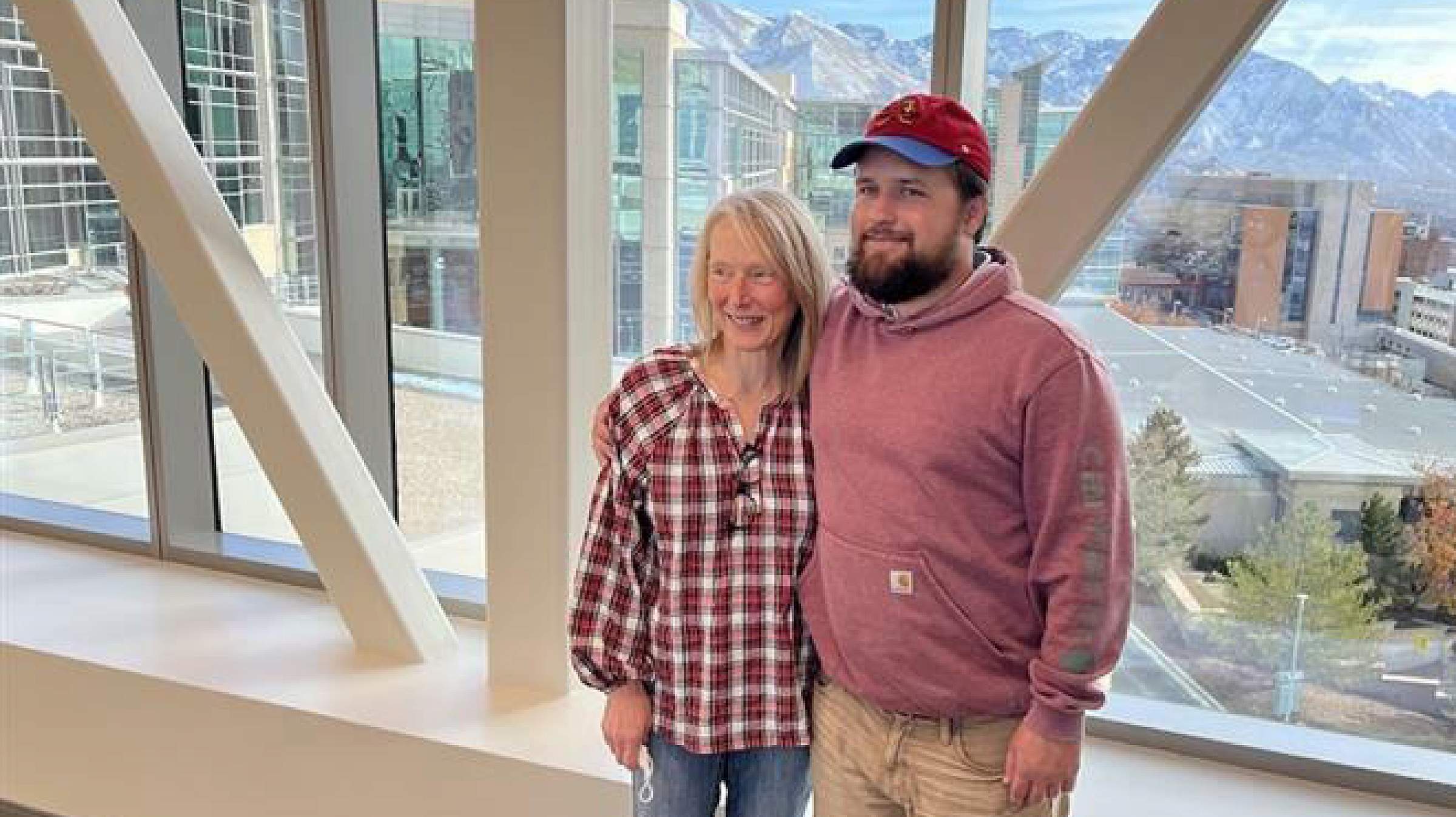 Doug Woods and Gina Poirier standing on the skybridge at Huntsman Cancer Institute
