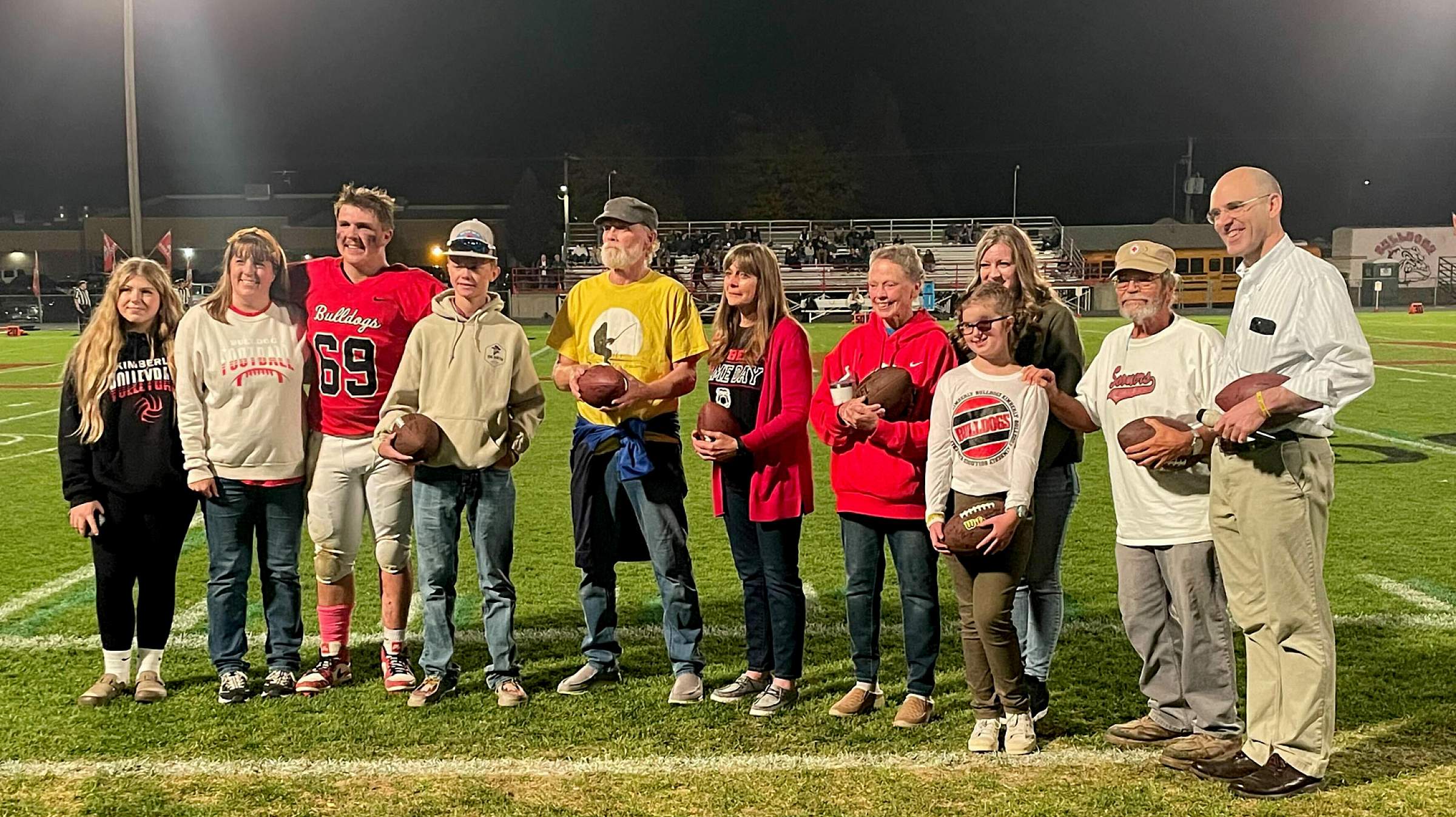 Gunner and Dr. Jones stand with local cancer survivors during halftime