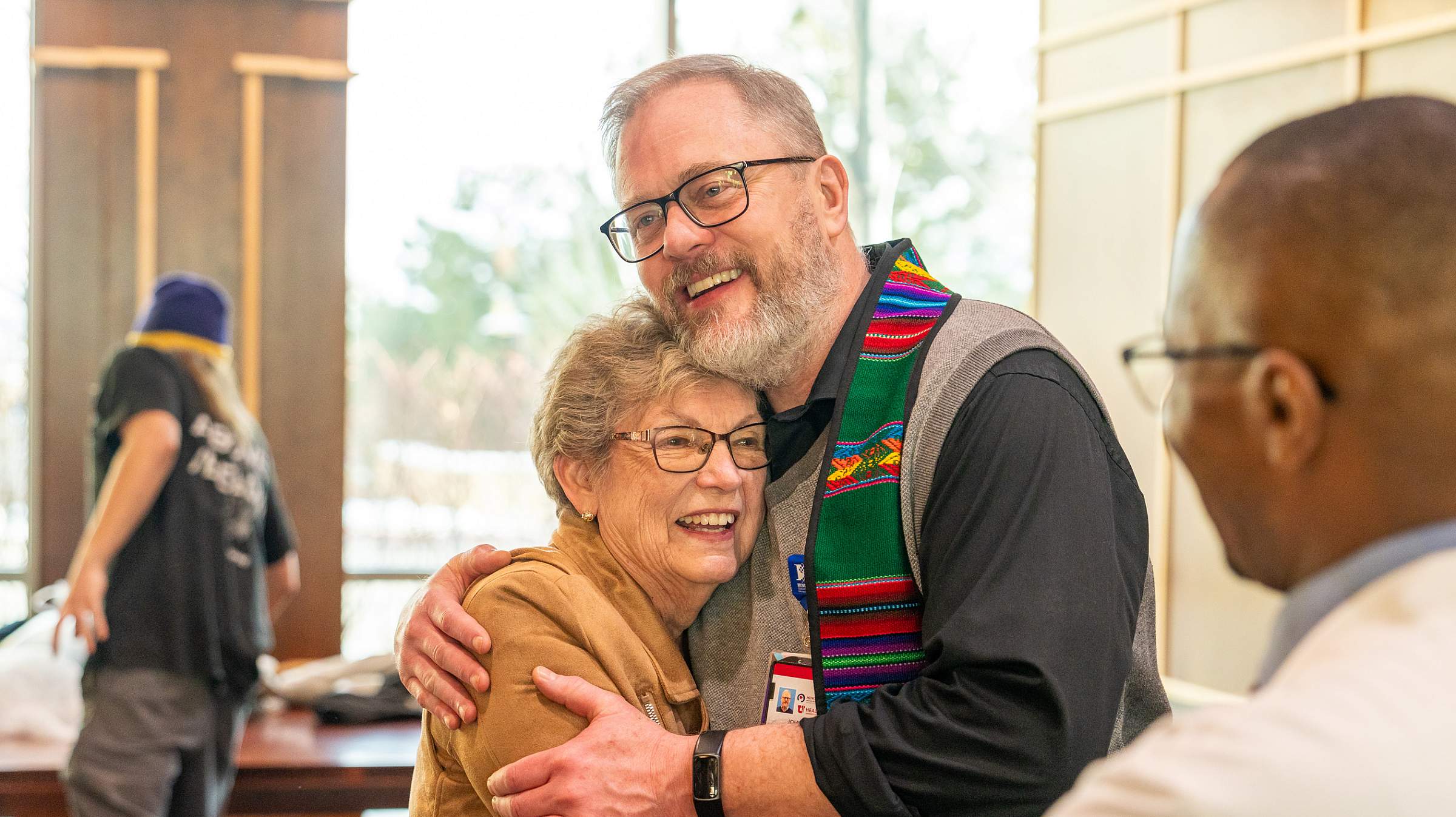 Karon hugging John Cooper, a chaplain at Huntsman Cancer Institute