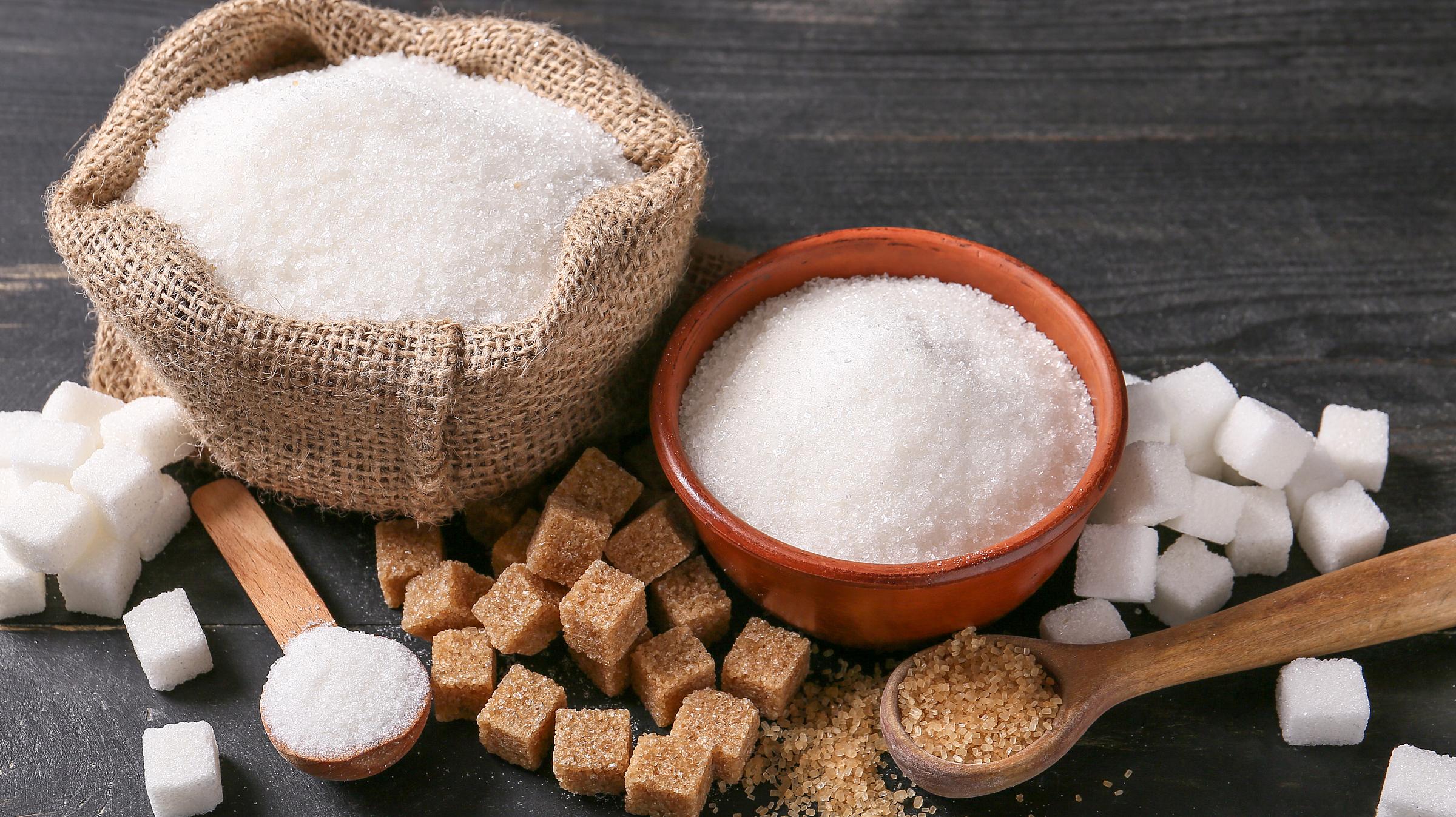 Piles and cubes of various types of sugar on a table