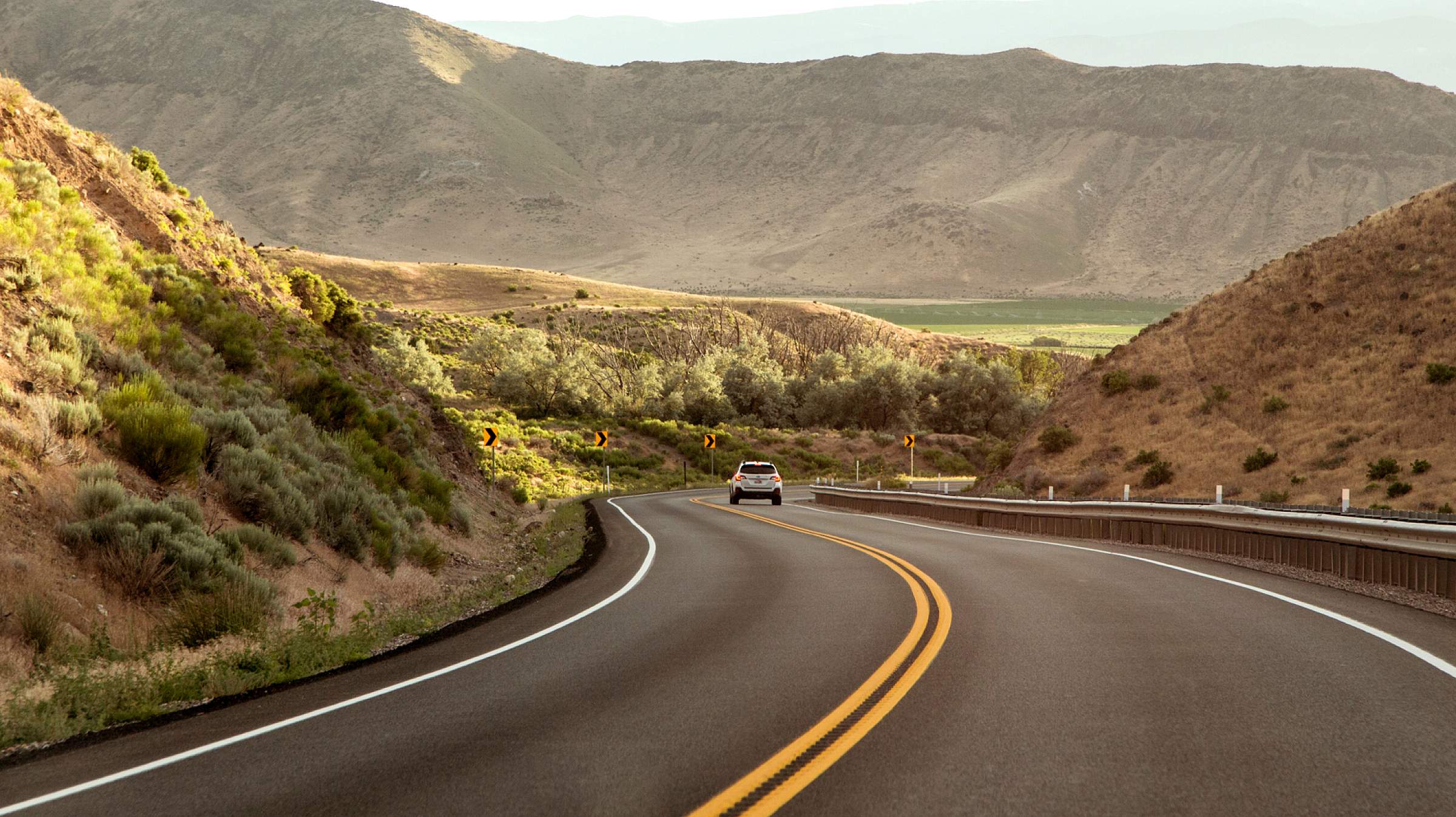 Car driving down long road