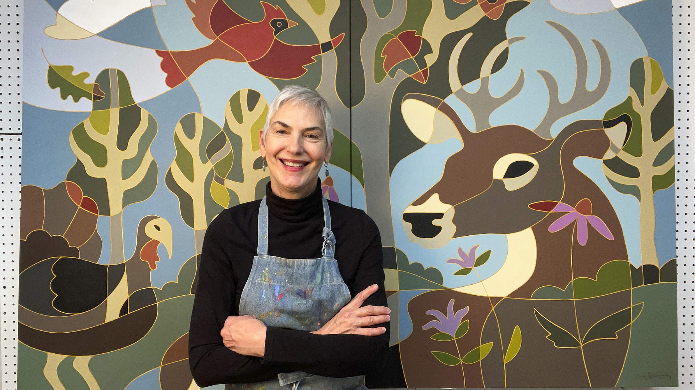 Traci O’Very Covey in front of a mural