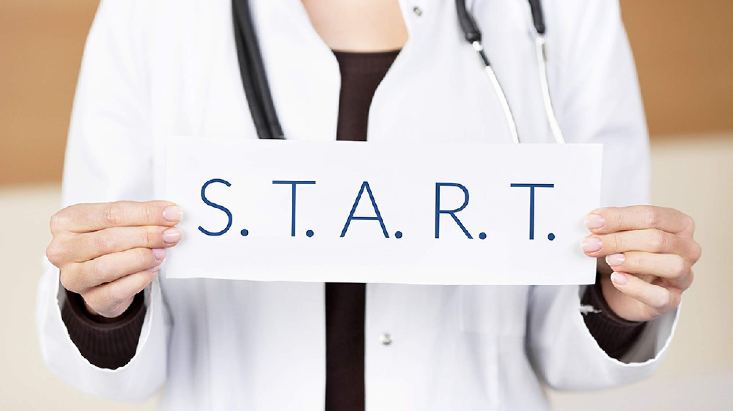 Doctor holding a paper that says S.T.A R.T