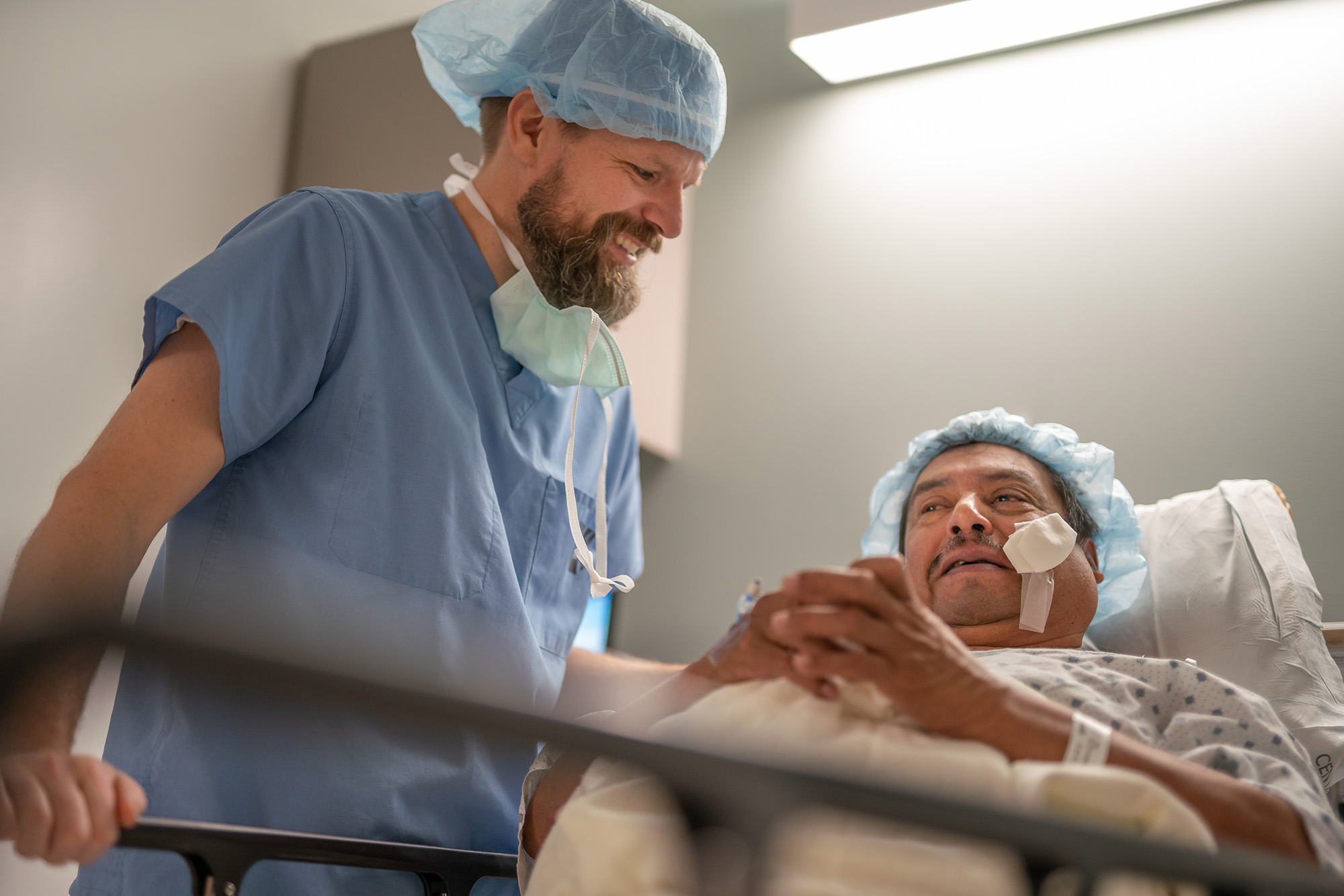 Jeff Pettey, MD, outreach division co-medical director, examines a patient after cataract surgery as part of Operation Sight Day on January 12 at the John A. Moran Eye Center.