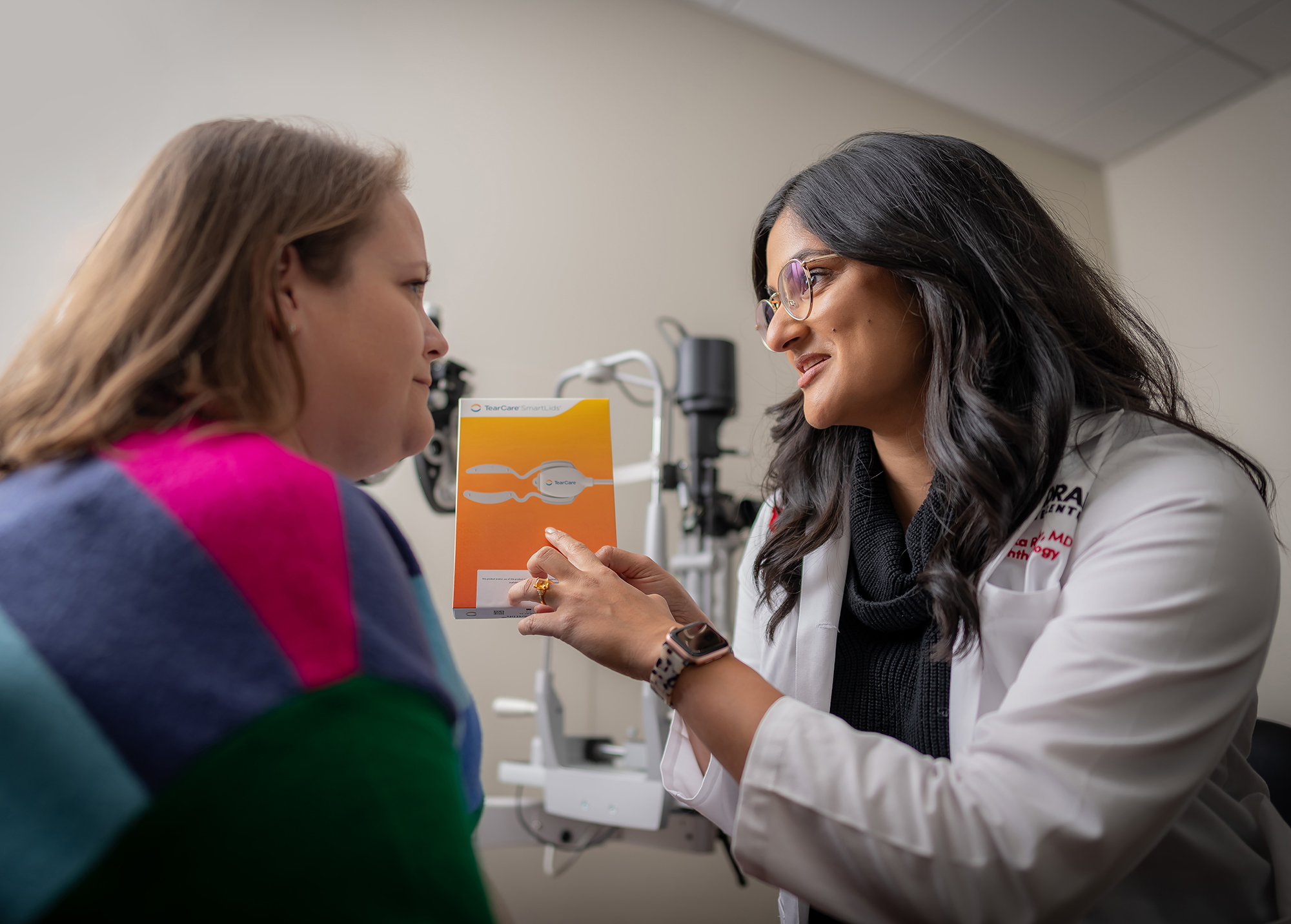 Nishika Reddy, MD, right, and a patient discuss a new treatment option for extreme dry eye available at the Moran Eye Center.