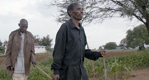 Matias is lead with a walking stick by his brother, Boniface.